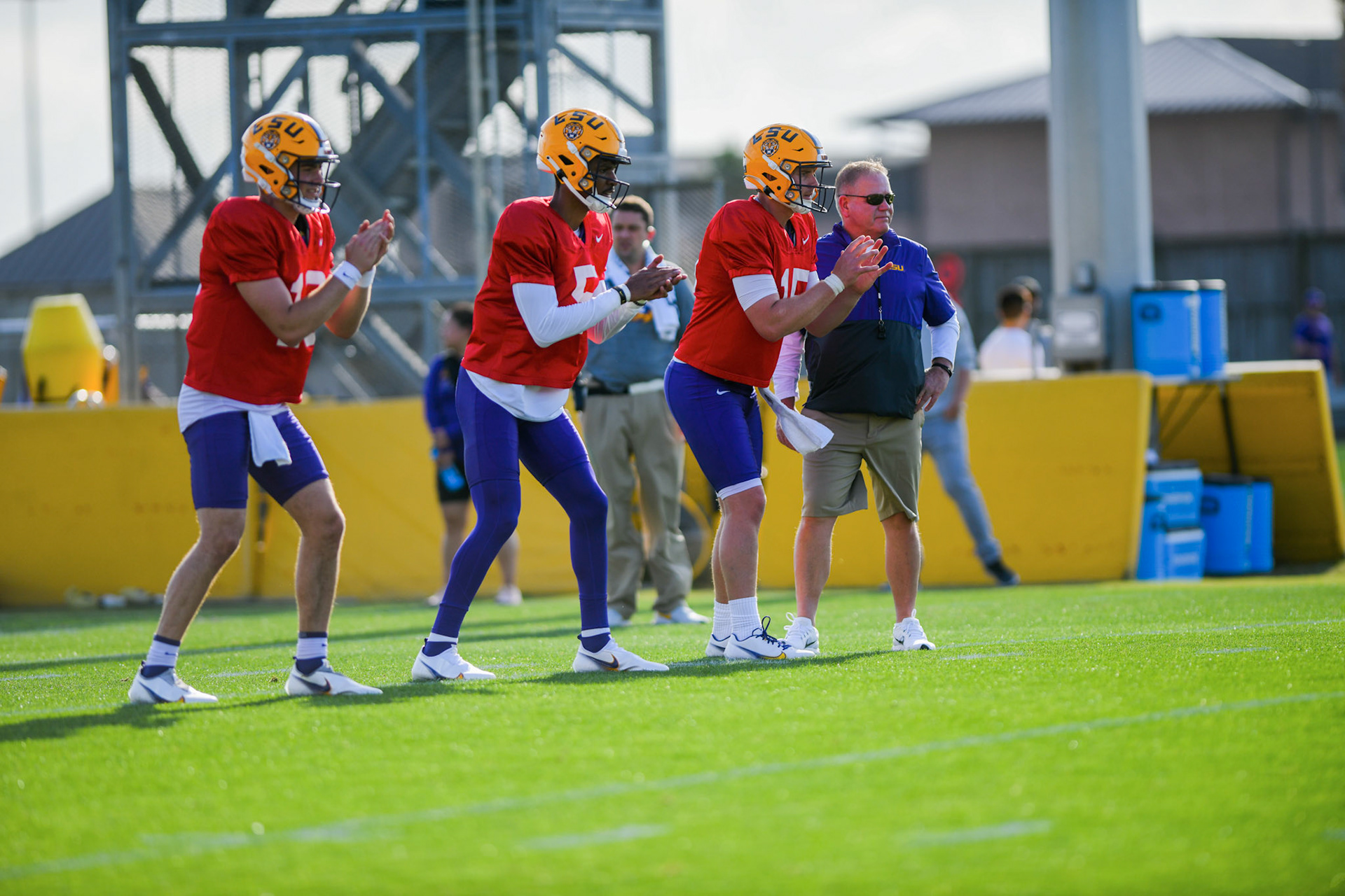 LSU football quarterbacks Garrett Nussmeier (13), Jayden Daniels (5), and Myles Brennan (15) wait to receive the ball Tuesday, March 29, 2022 during LSU's spring practice in Baton Rouge, La.