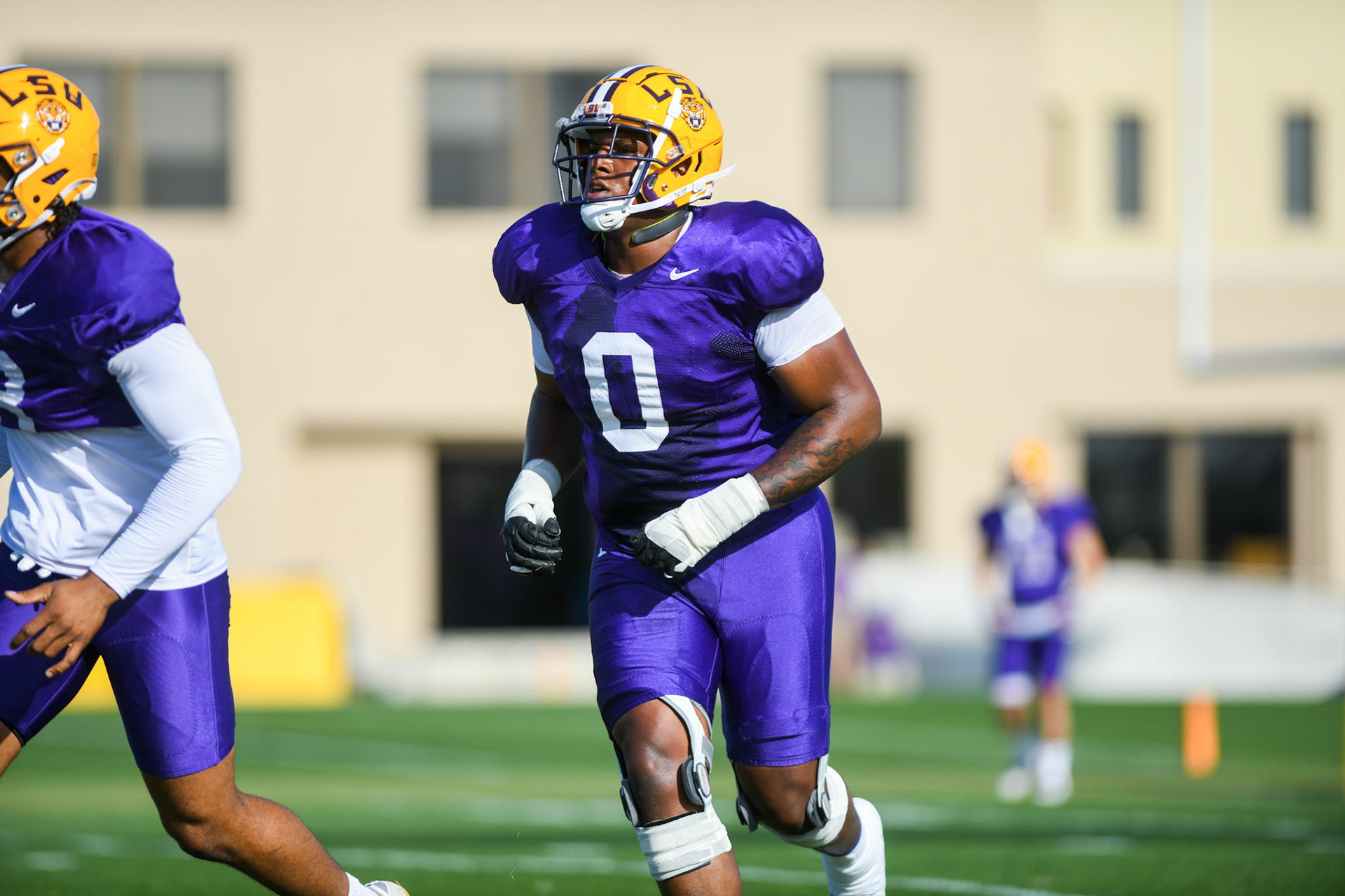 LSU football defensive lineman Maason Smith (0) runs to the huddle Tuesday, March 29, 2022 during LSU's spring practice in Baton Rouge, La.