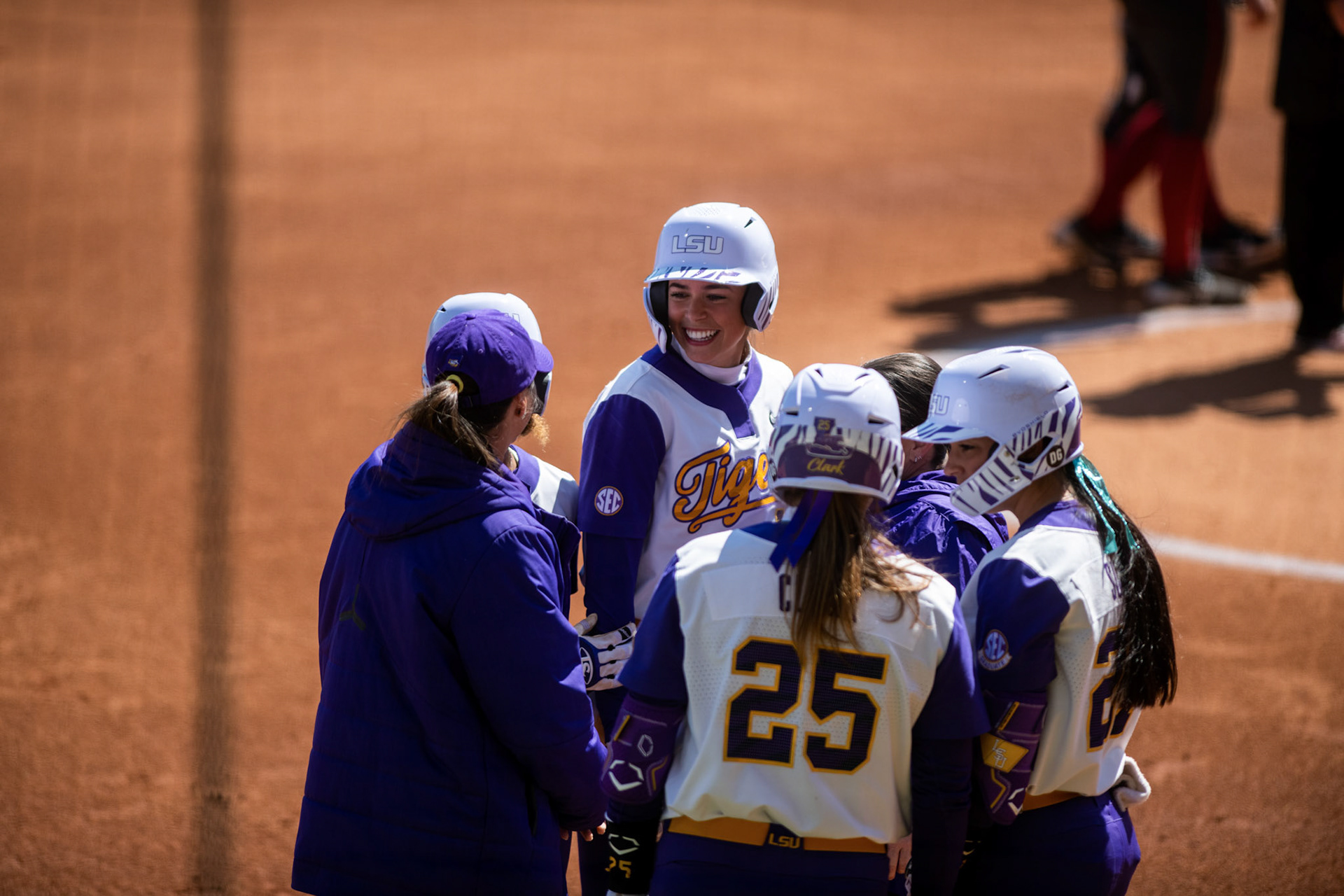LSU softball head coach Beth Torina talks to redshirt sophomore infielder Taylor Pleasants (17), redshirt junior infielder Georgia Clark (25), and 5th-year senior pitcher/utility Shelbi Sunseri (27) Saturday, March 12, 2022 during LSU's 13-6 win against Alabama at Tiger Park in Baton Rouge, La.