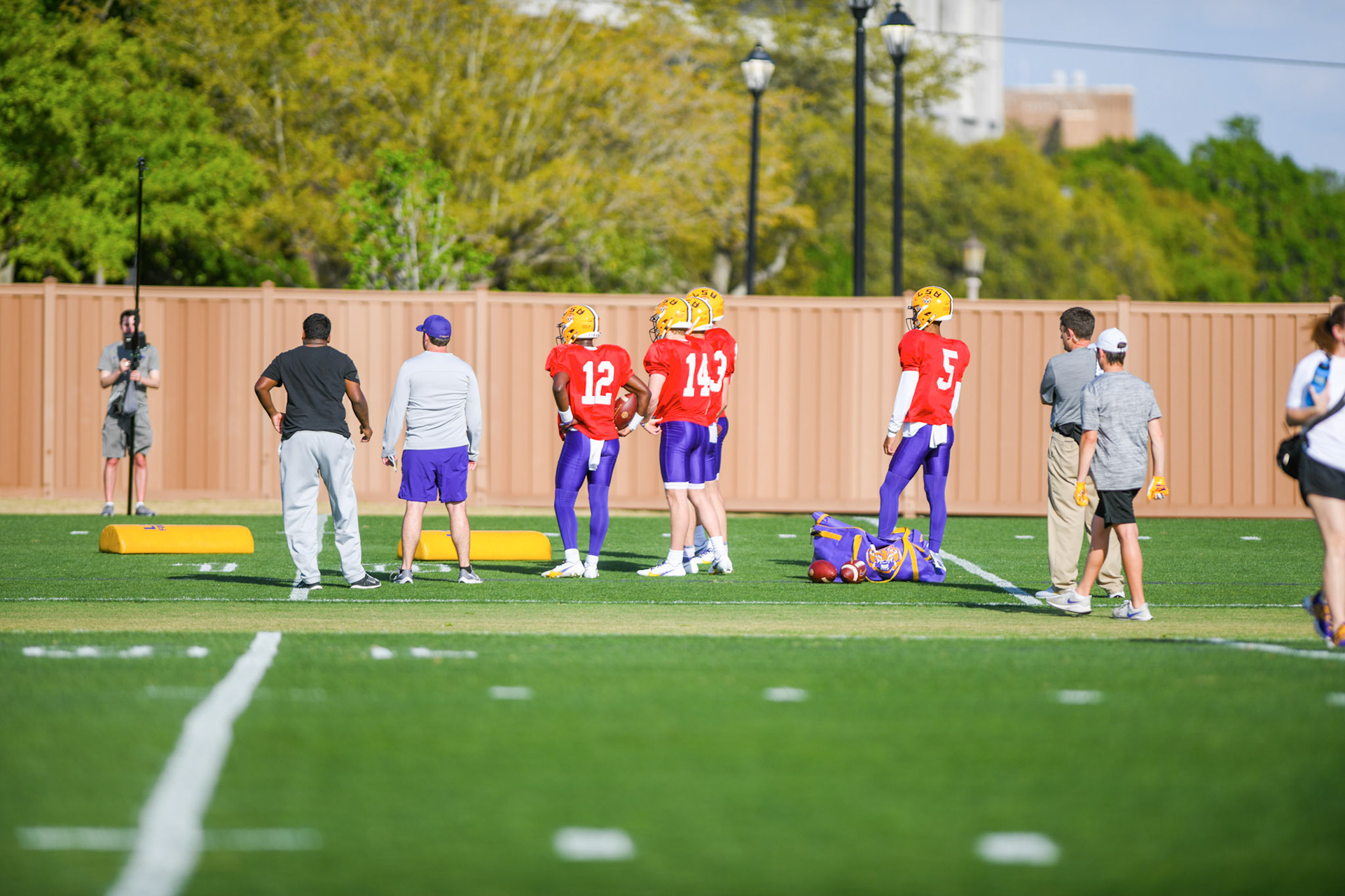 LSU football quarterbacks stand off to the side Tuesday, March 29, 2022 during LSU's spring practice in Baton Rouge, La.