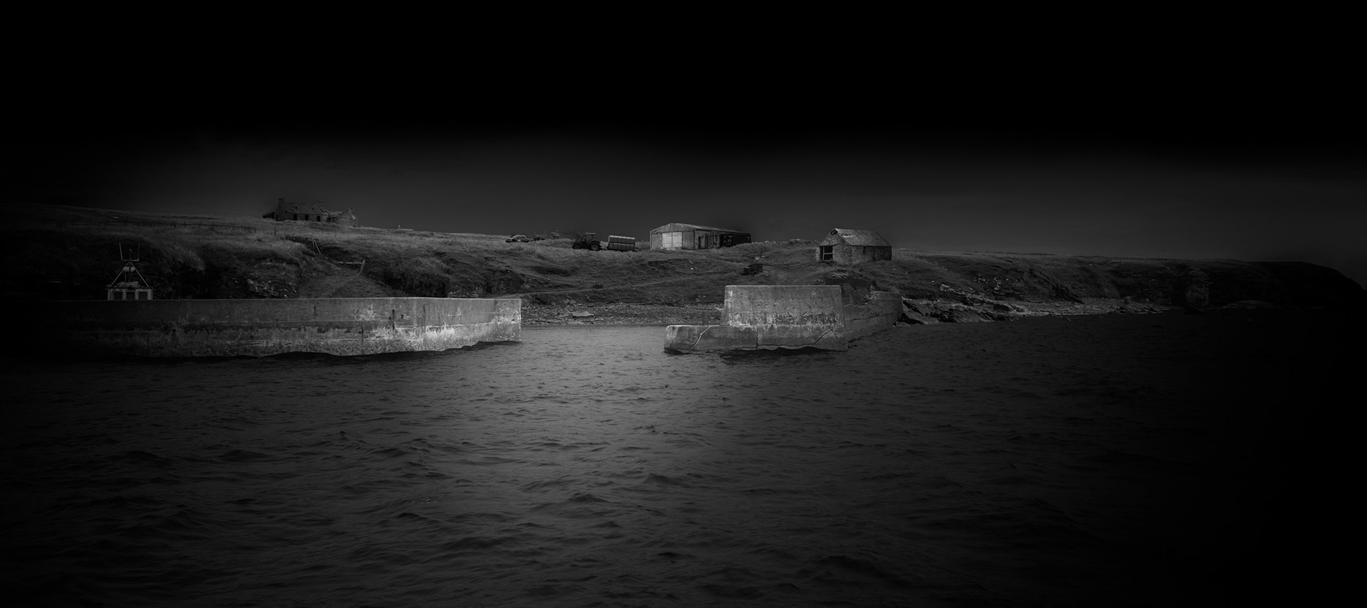 Stroma lies barely two miles from the Caithness coast and can appear tantalisingly accessible from the mainland. Between the two, however, flows the Pentland Firth, whose powerful tidal streams have always defined the island's relationship with the outside world. Approaching Stroma by boat reveals the island gradually: its low profile rising from the water before the harbour, buildings and remnants of settlement become apparent. This photograph deliberately places the island within that surrounding expanse of sea. It acts as an introduction to a place that is geographically close yet historically isolated, and to a landscape where the remains of human occupation can still be discerned against the much larger forces of water, weather and time.Stroma is an ongoing photographic project which I am currently developing.