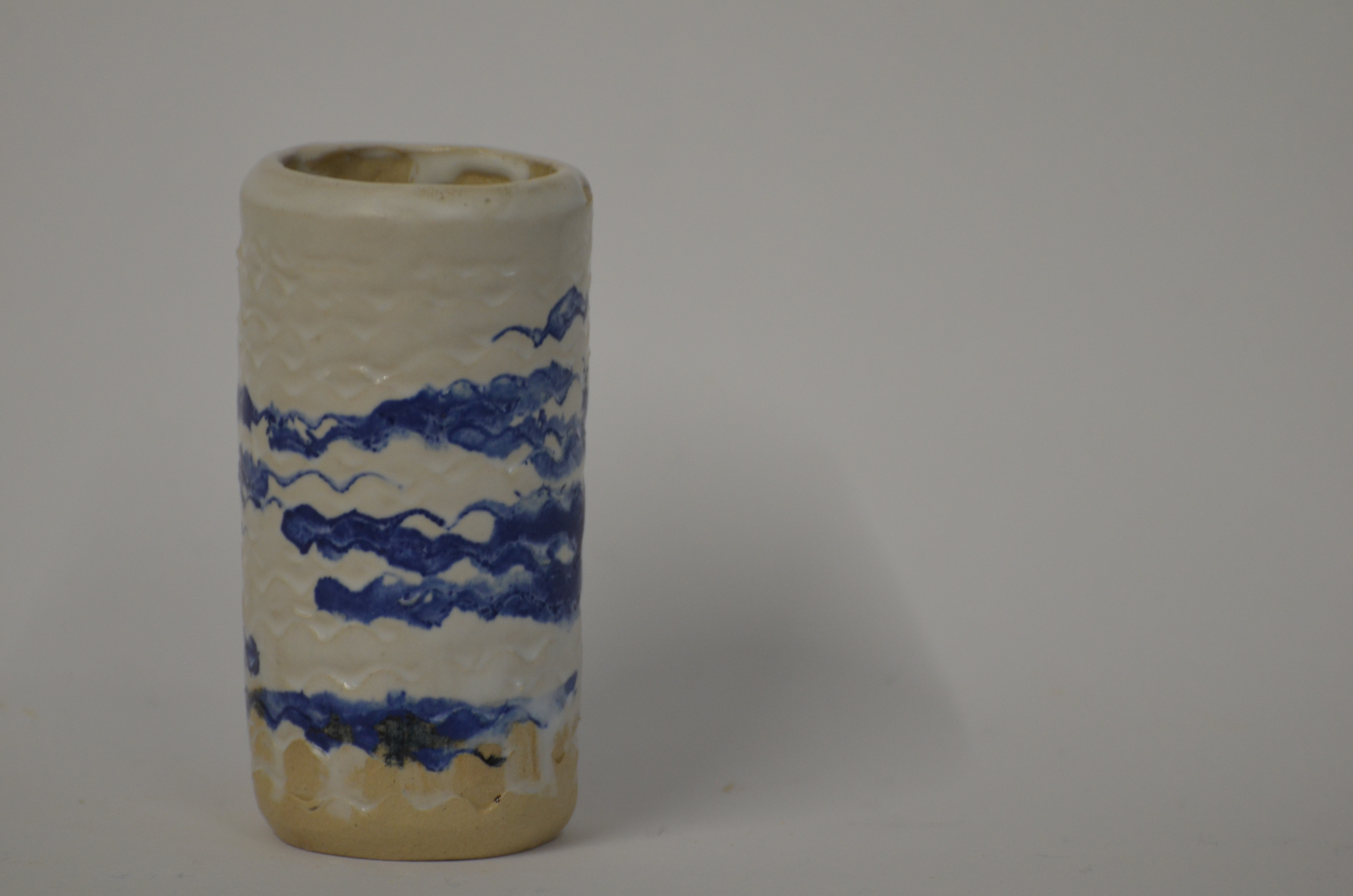 Tools meant for encaustic wax painting were used to create a sea like feeling which was highlighted with cobalt oxide.