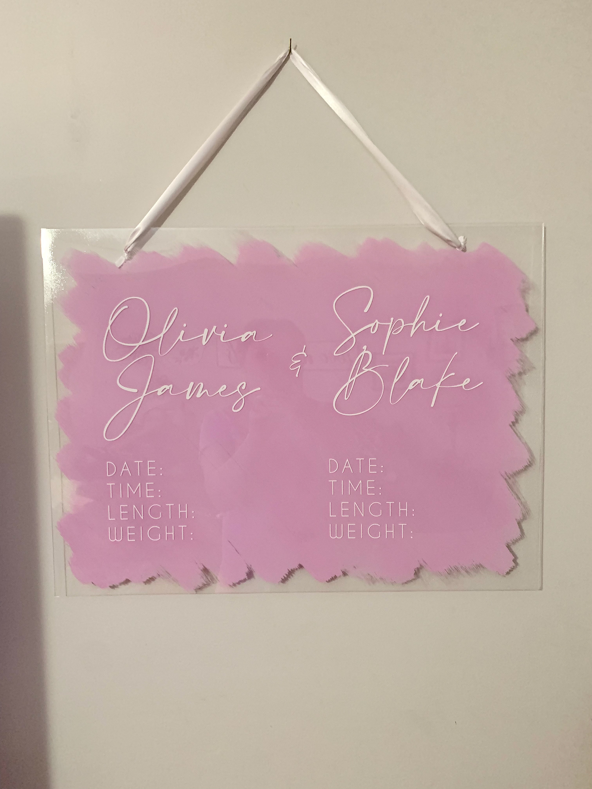 Acrylic Plexiglass with acrylic paint, satin ribbon and vinyl lettering.