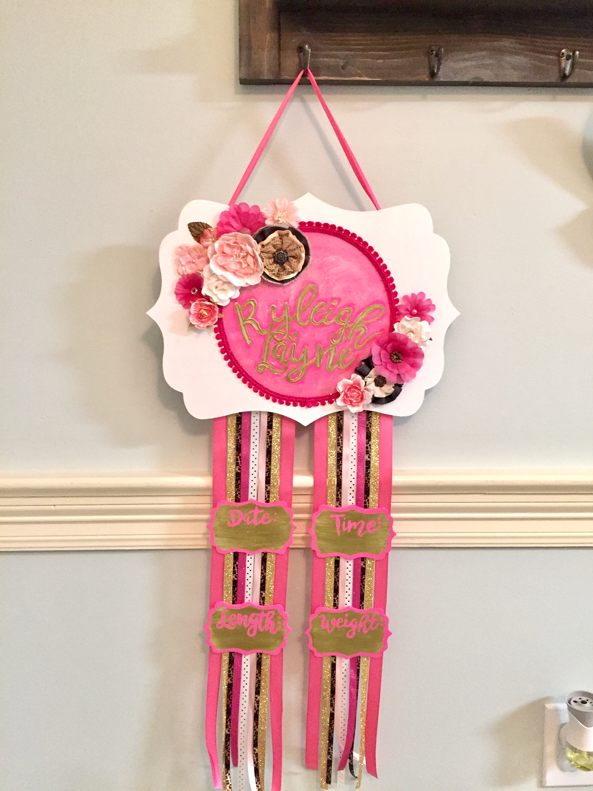 Painted wood sign and tags with ribbon and fabric flower accents.