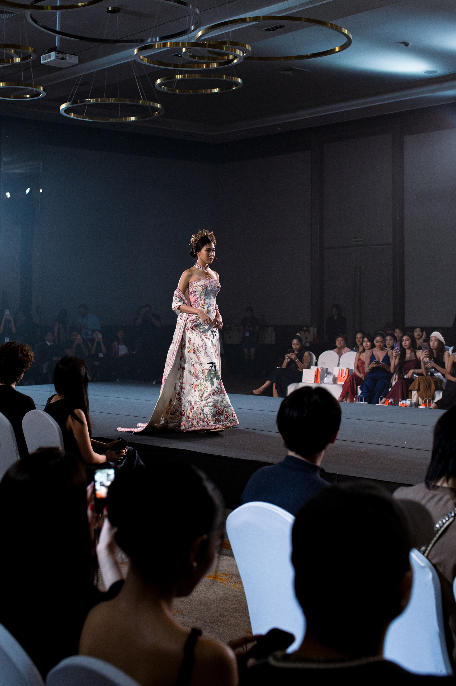 A model walking the runway in a traditional-inspired ornate gown at Thailand Fashion Week in Bangkok.