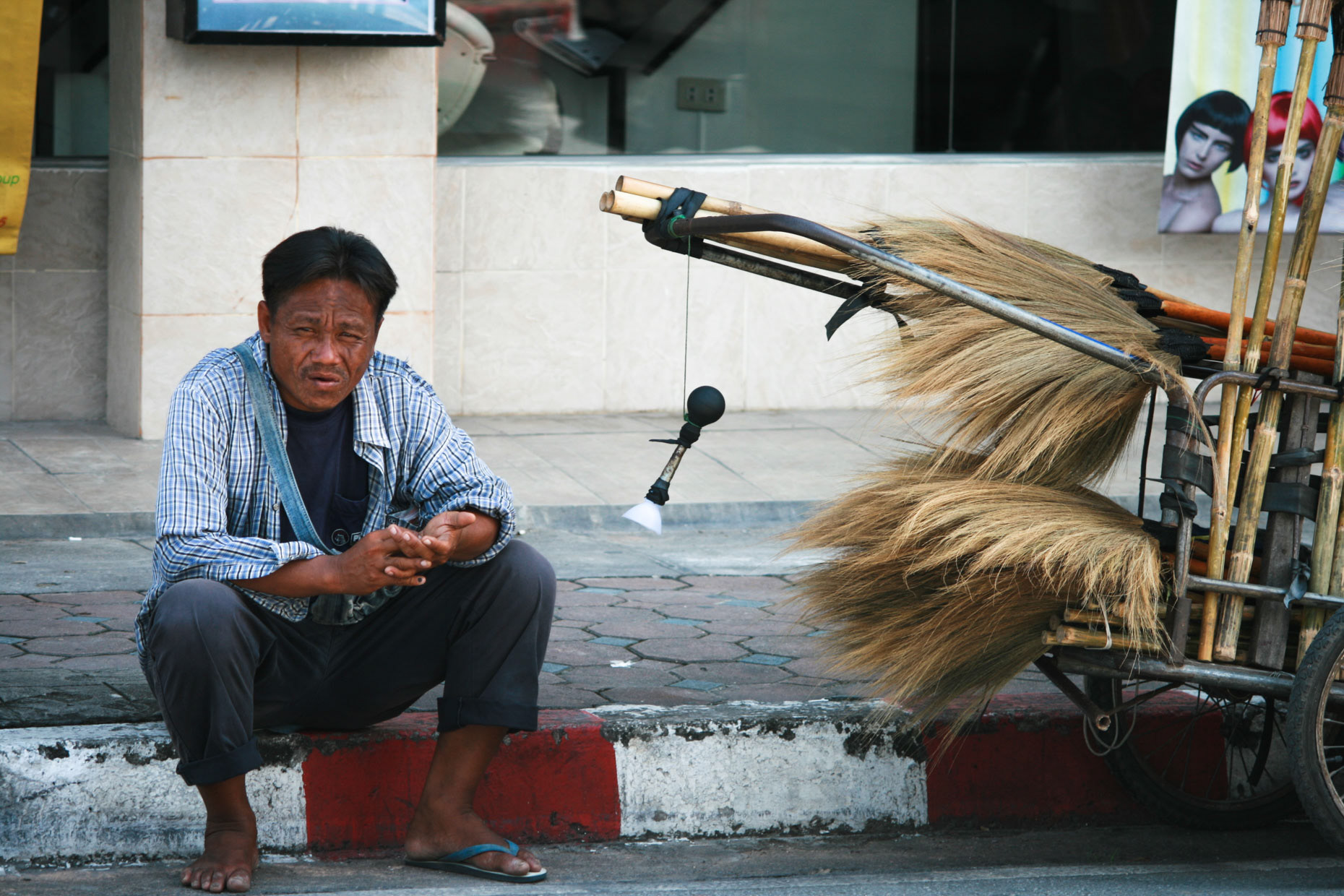 A fly-pitcher taking a break in September 2008 on a sidewalk in Chiang Mai, Thailand.