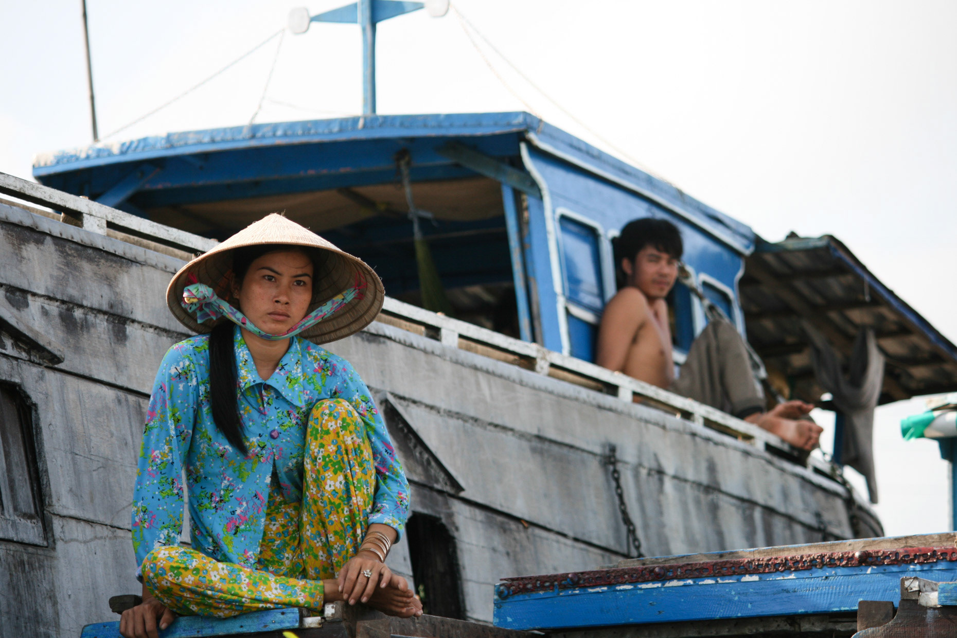 A couple watching life on the water from their houseboat in October 2008 in the Mekong Delta, Vietnam.