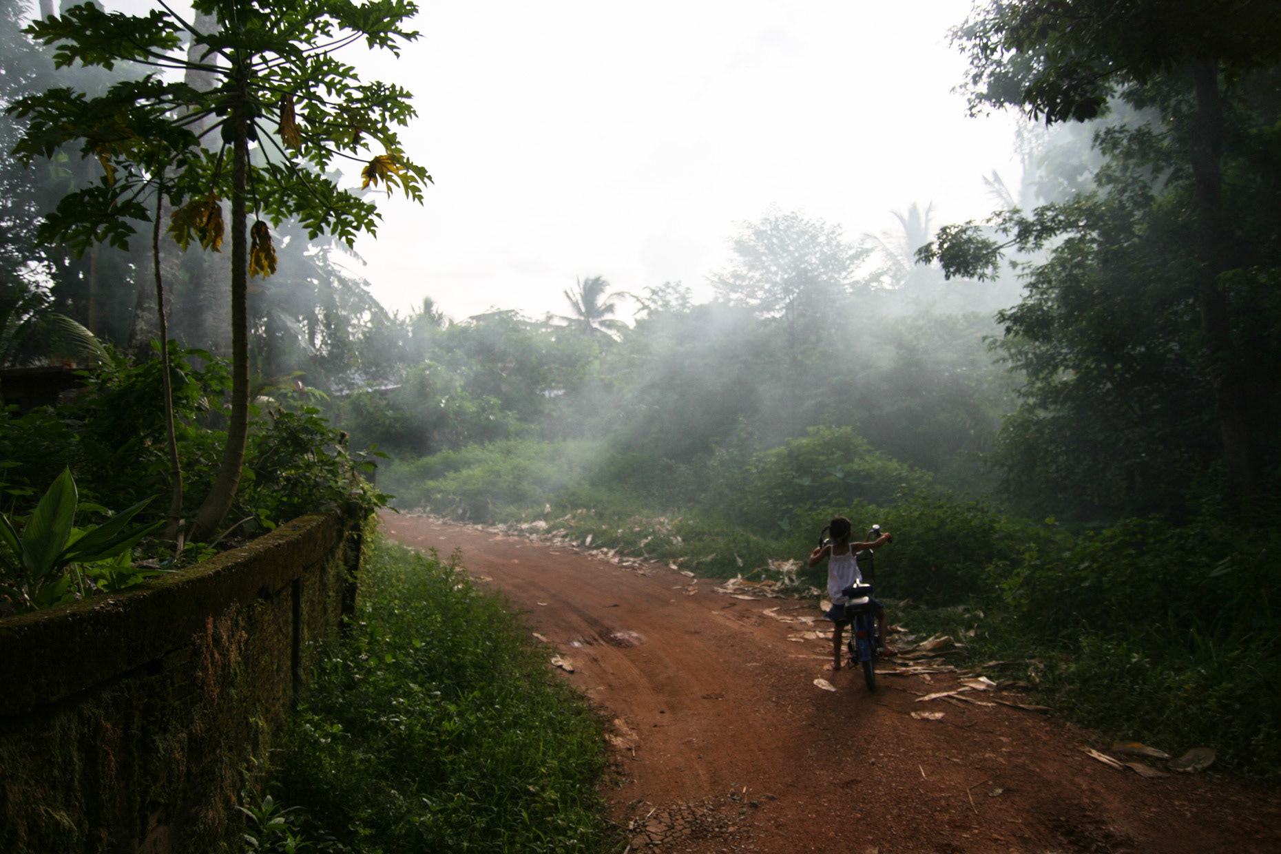A young girl setting off on her bicycle in September 2008 near Vang Vieng in Laos.