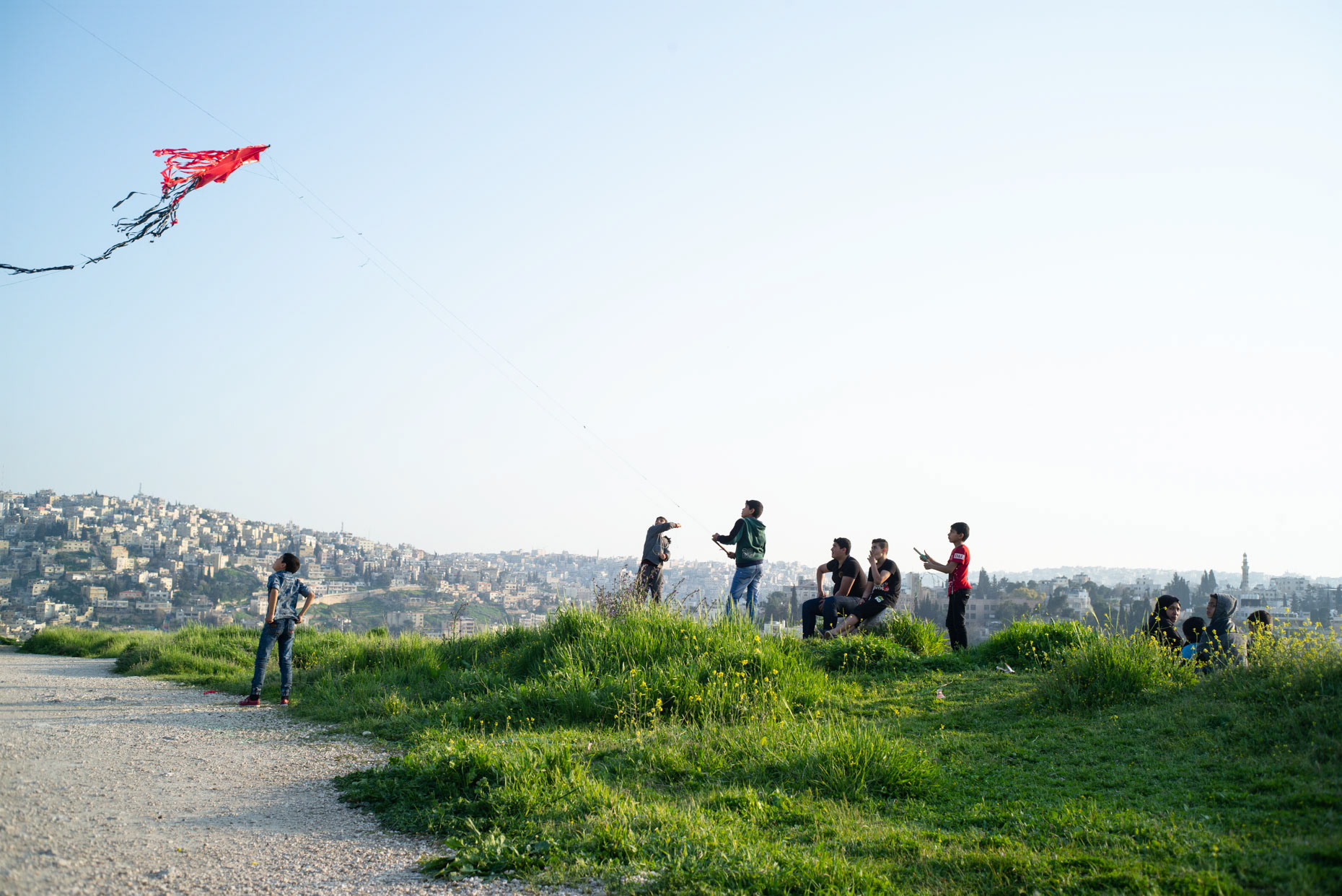 Children flying their kites on the Citadel in March 2019 in Amman, Jordan.