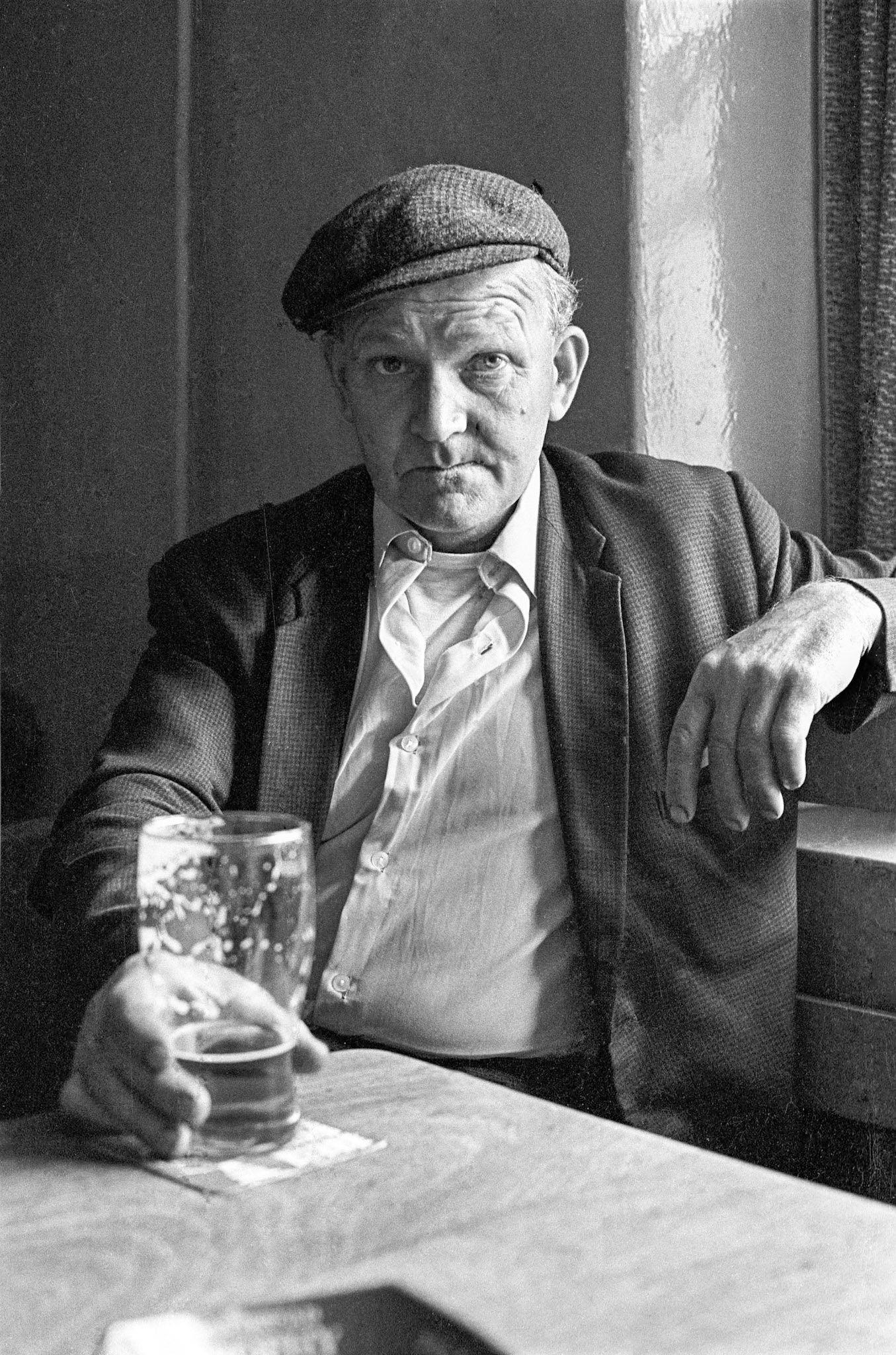 Raymond Owen - A typical Welsh collier. Sitting near the window in the Red Lion in the afternoon. Most old colliers loved the countryside. They were very at one with nature. Spending so much time in hostile conditions underground the appreciated sunshine and clean air. His father was a farmer. Raymond worked nights for most of his life. He would have a few pints in the Red Lion, go home for a meal then fall asleep for a few hours. By ten he would be underground at the coalface.