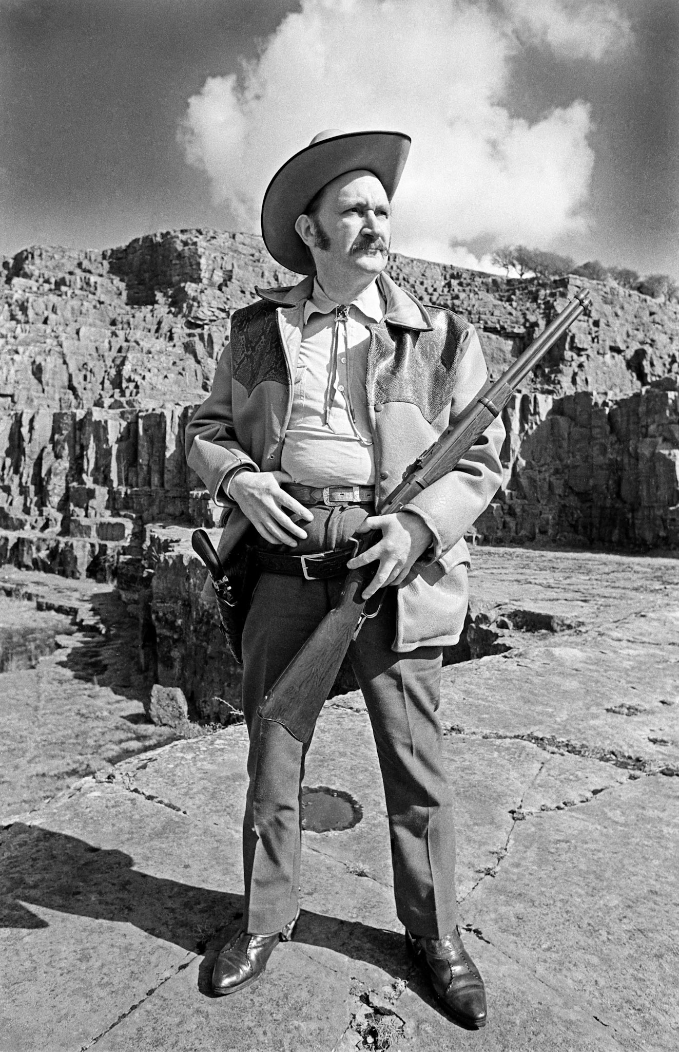 Tex Jones - Tex was the father of my school friend Wayne. He lived on the Gurnos Estate and was crazy about the Wild West. He was a very skilled leather worker and made belts, wallets and all sorts of things. He made a stool out of a Western Saddle and perched on it he would eat baked beans from a tin while watching Westerns on the television. I photographed him at Morlais Castle quarry not far from his home.