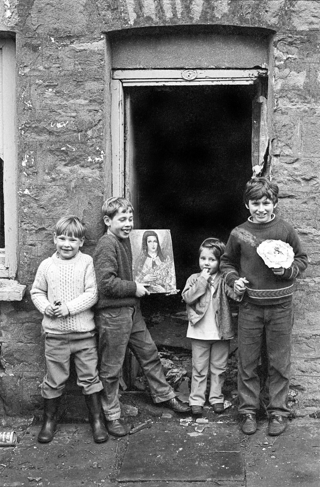 Children playing in a derelict house in Georgetown, Merthyr - They found a painting inside the building and asked me to photograph them with it. The redevelopment of Georgetown had started and houses were being cleared.