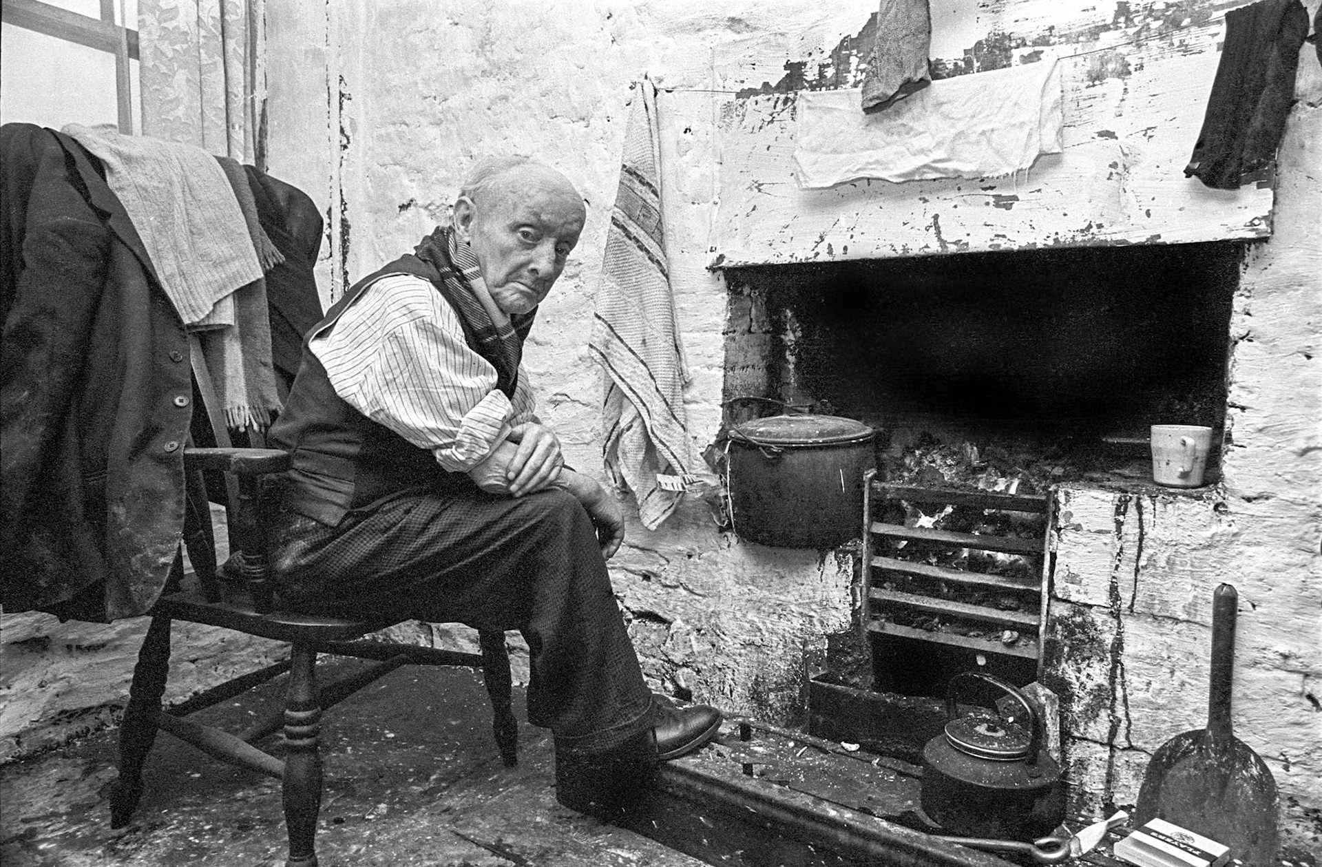 Old Phil - He was ninety-three and lived in an old lodging house known as the Castle Hotel. Here he is sitting next to the fireplace in the kitchen. It was amazing how well he looked after himself. Look at the shine on his shoes.