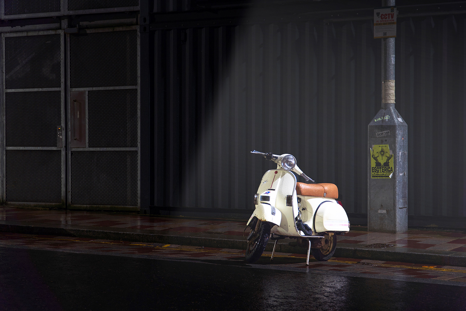Scooter under a street light on a damp night in the East End of Glasgow
