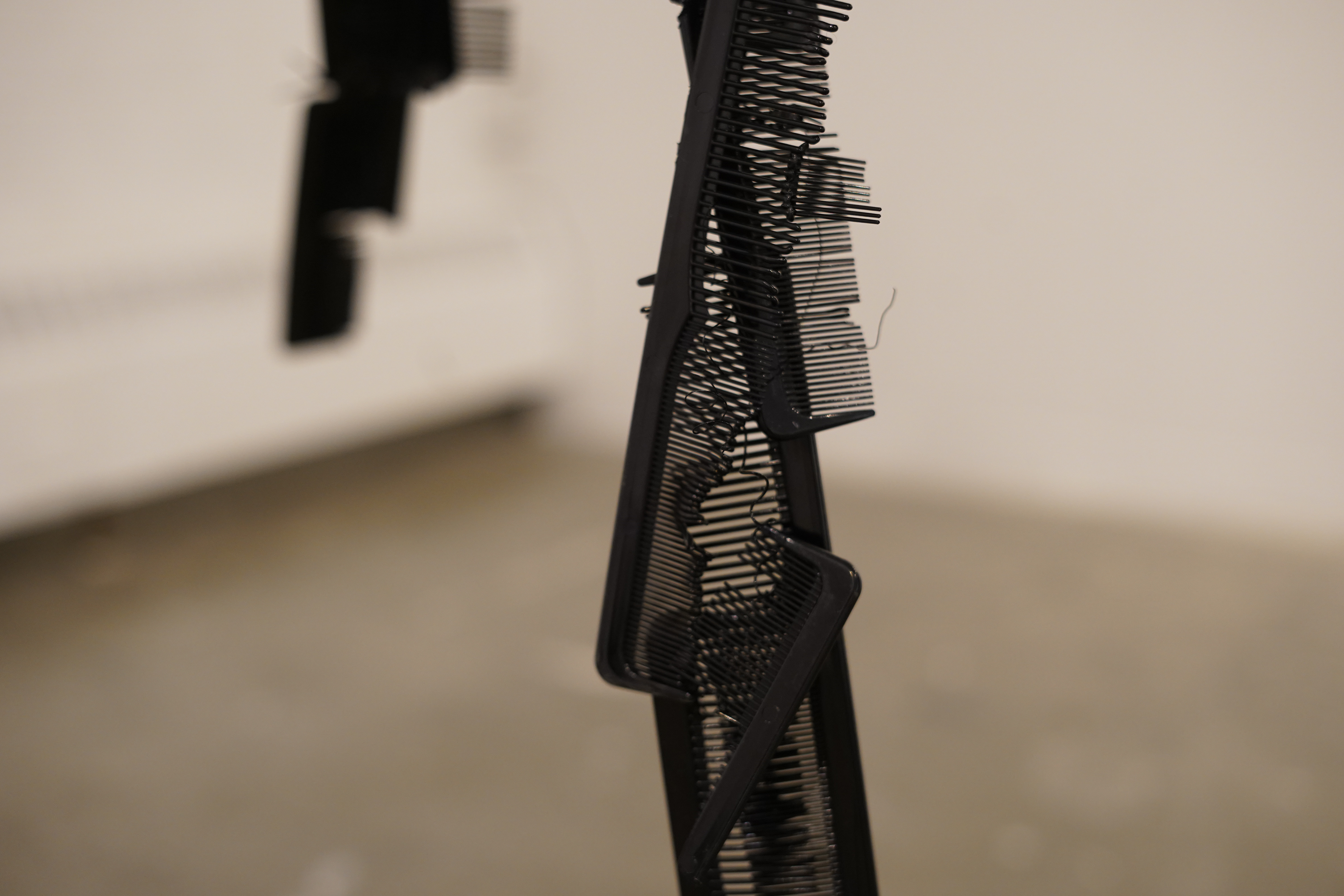 Kameo Chambers, Stranded (detailed), 2024, Plastic Combs, 21 in x 6 in x 24 in 