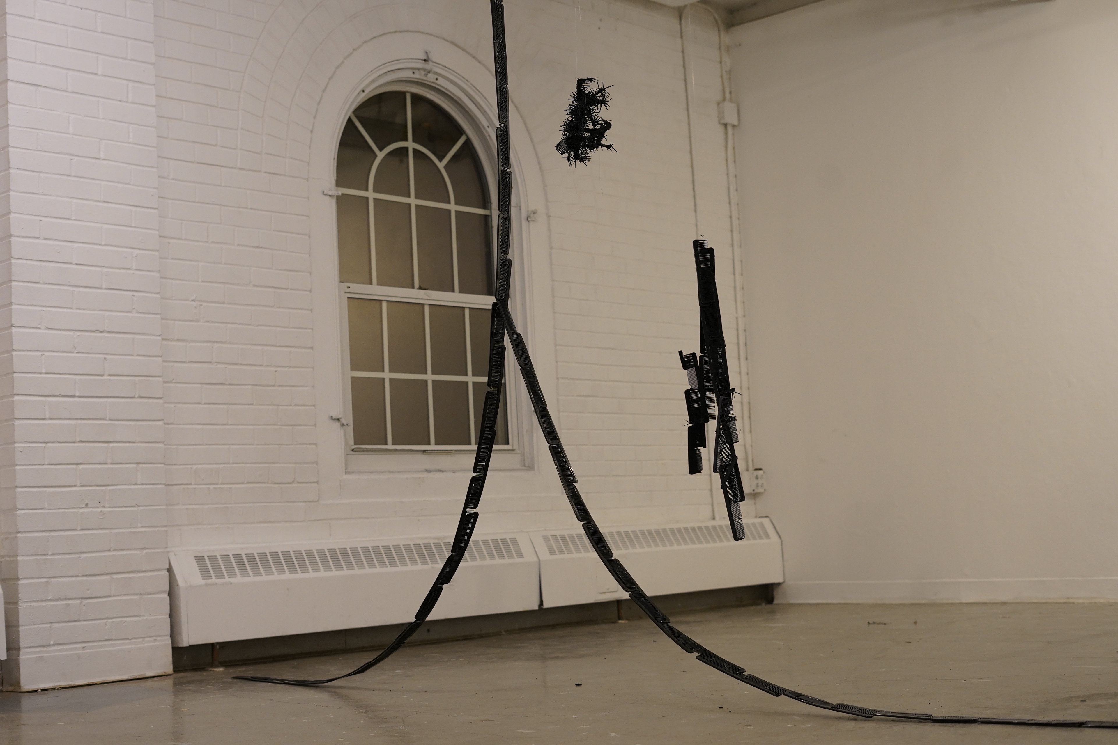 Kameo Chambers, Split Ends, 2024, Plastic Combs, 138 in x 2.5 in x 101 in 