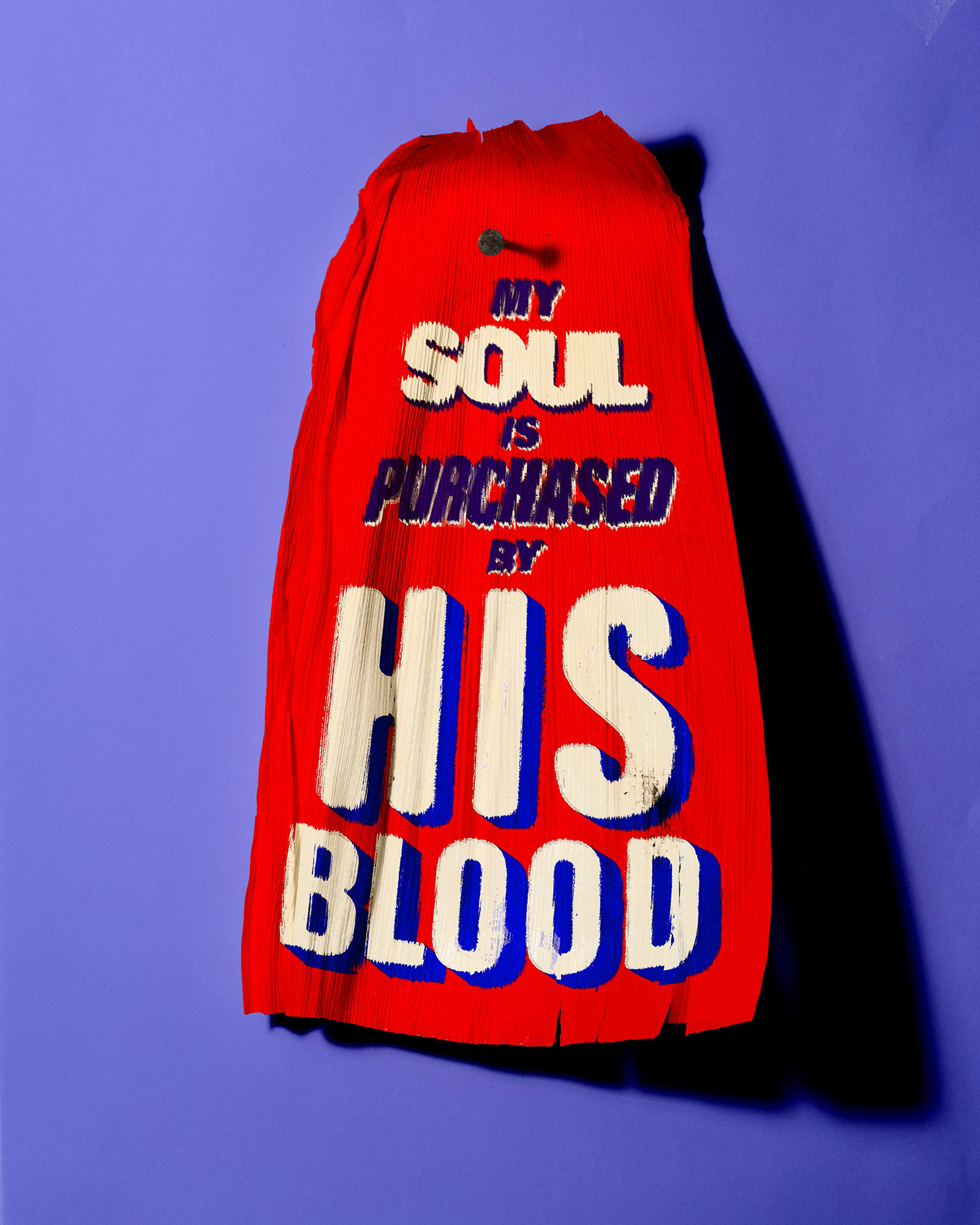 A tamale corn husk which says, "My soul is purchased by His blood."