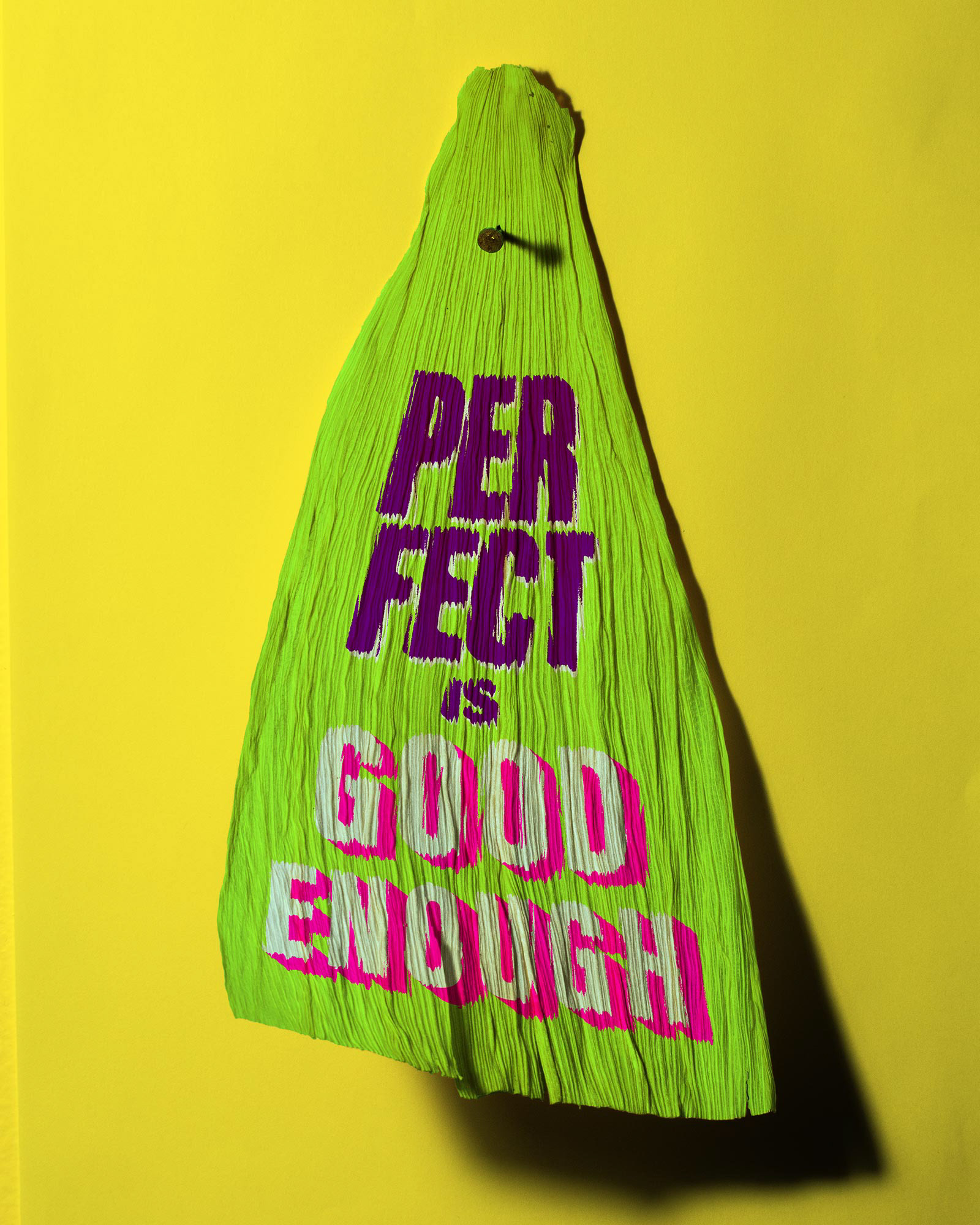 Tamale corn husk that says, "Perfect is good enough."