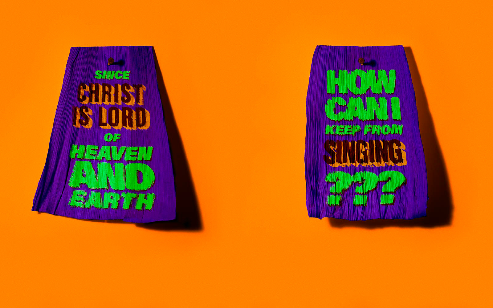 Tamale corn husk that says, "Since Christ is Lord of Heaven and Earth" paired with a tamale corn husk that says "How can I keep from singing?"