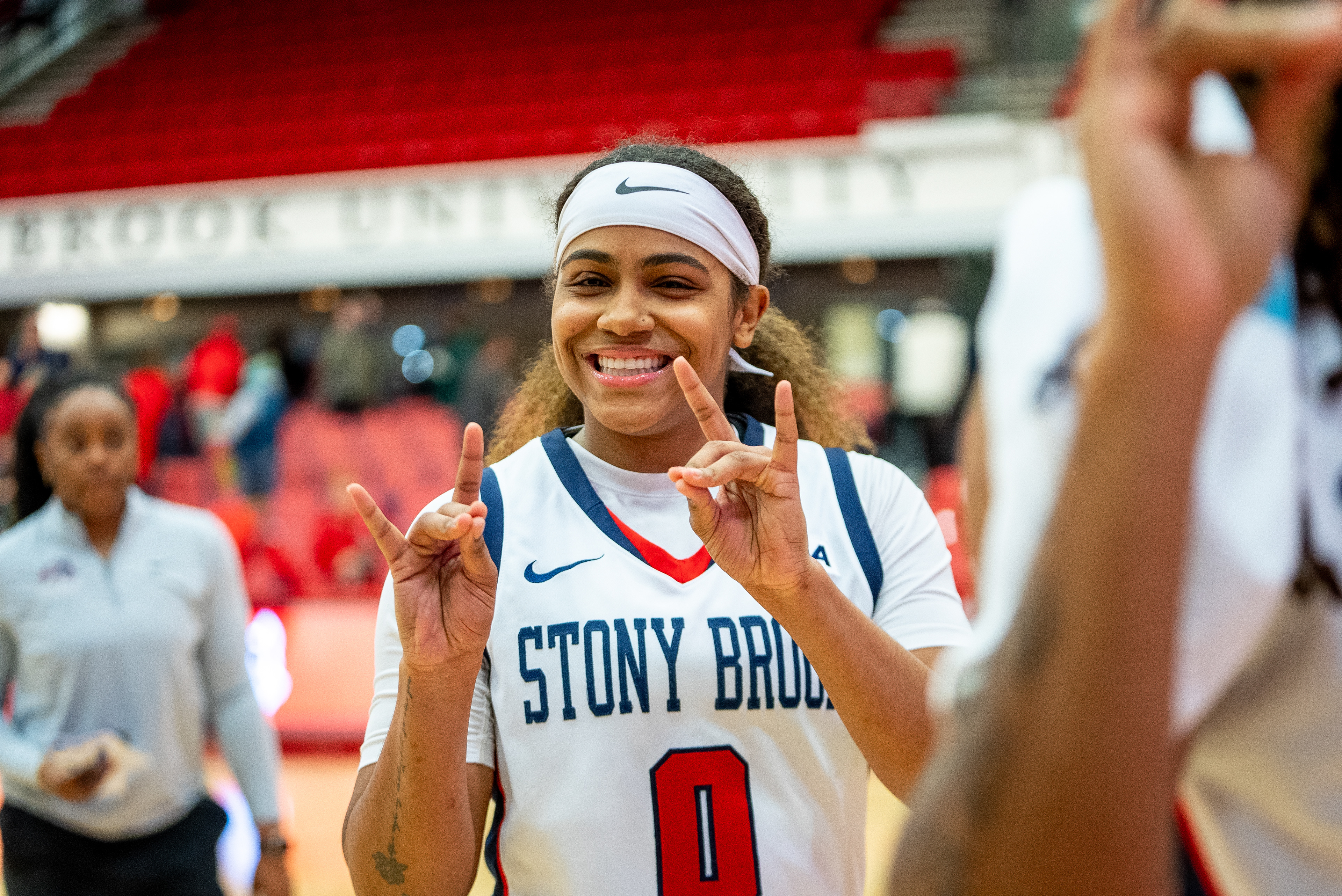 Gigi Gonzalez showing her wolfies with a big smile after a win - Stony Brook, NY 2/16/2024