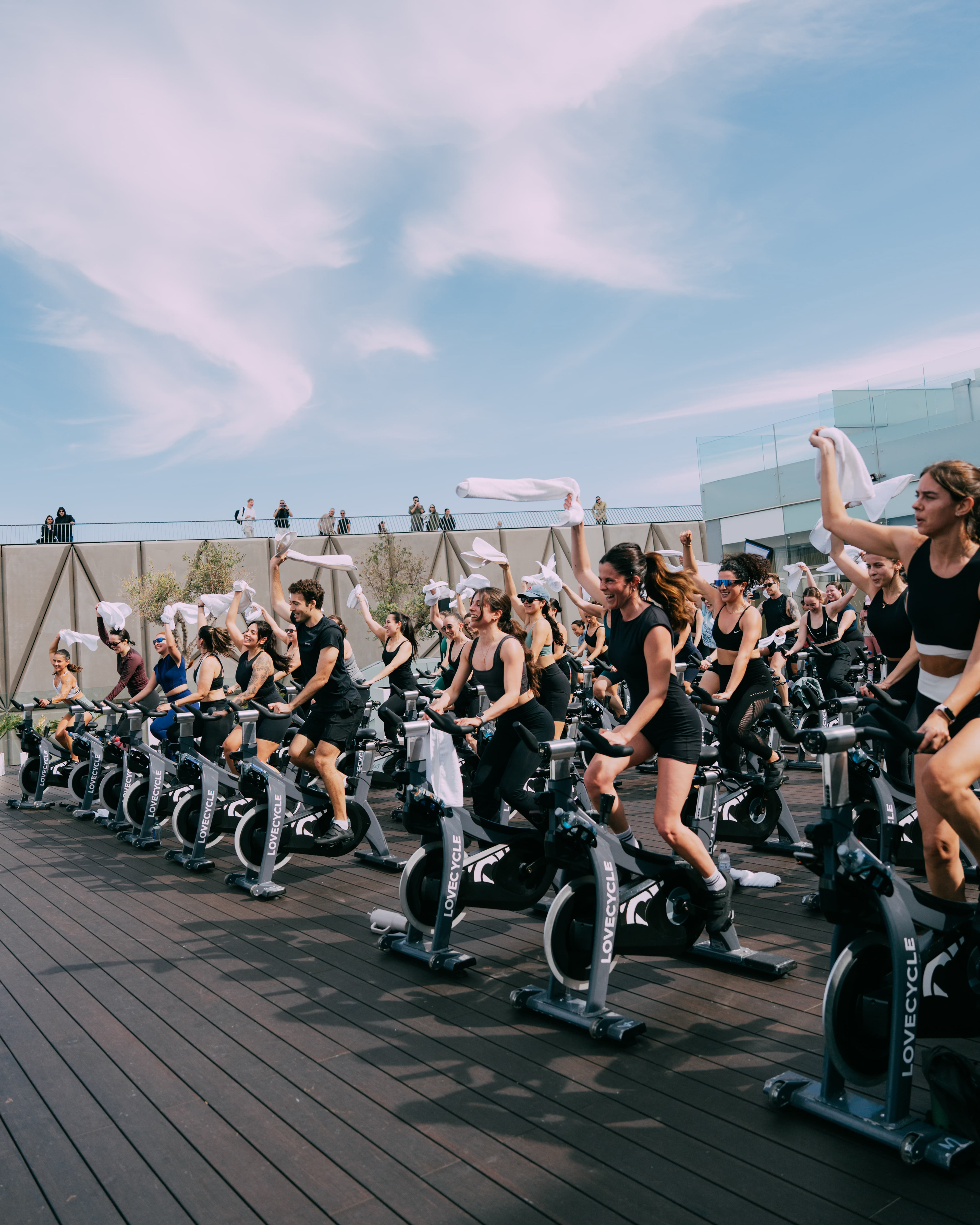 Wide view of the outdoor cycling class by the sea, Oysho x Lovecycle