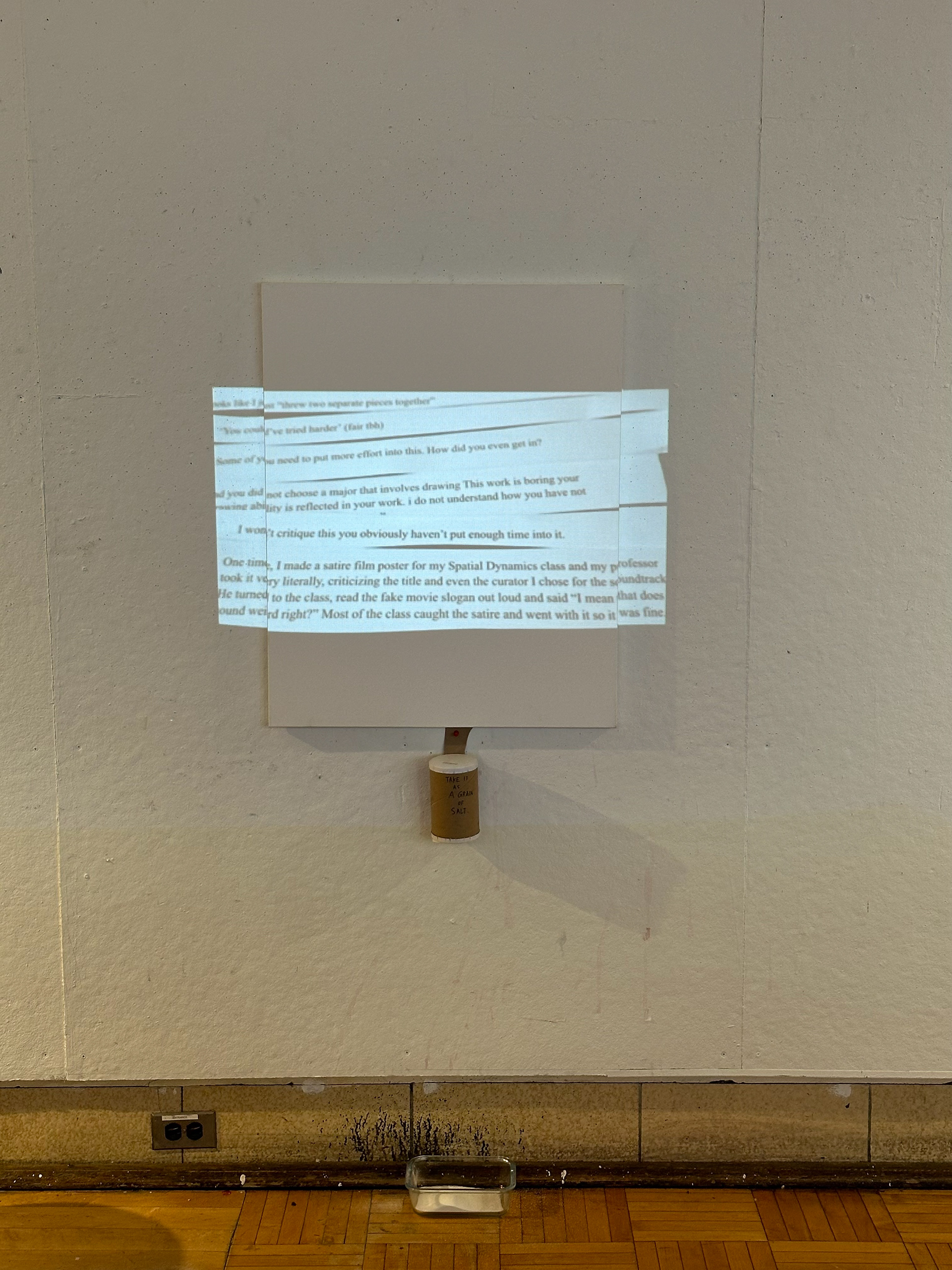 "Making Sand", a projection installation with canvas, salt, and container
