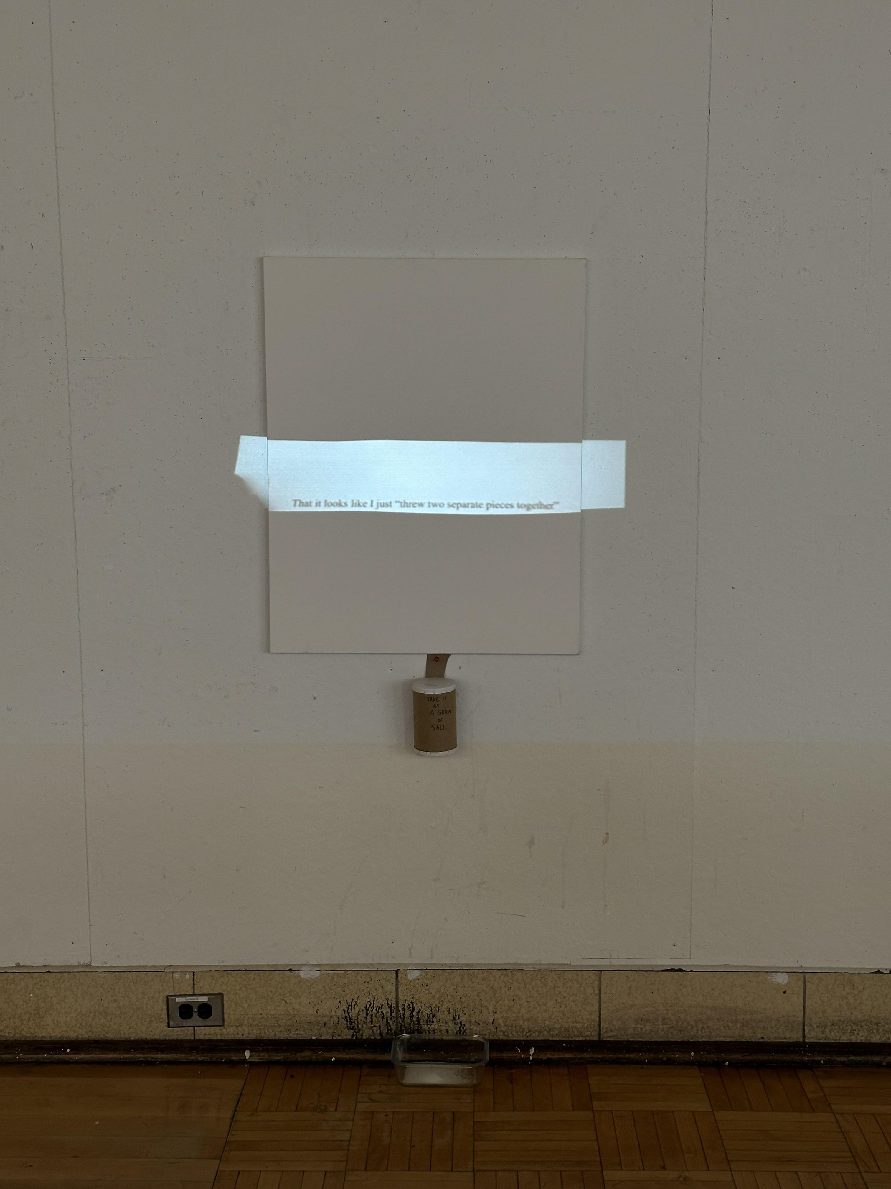 "Making Sand", a projection installation with canvas, salt, and container