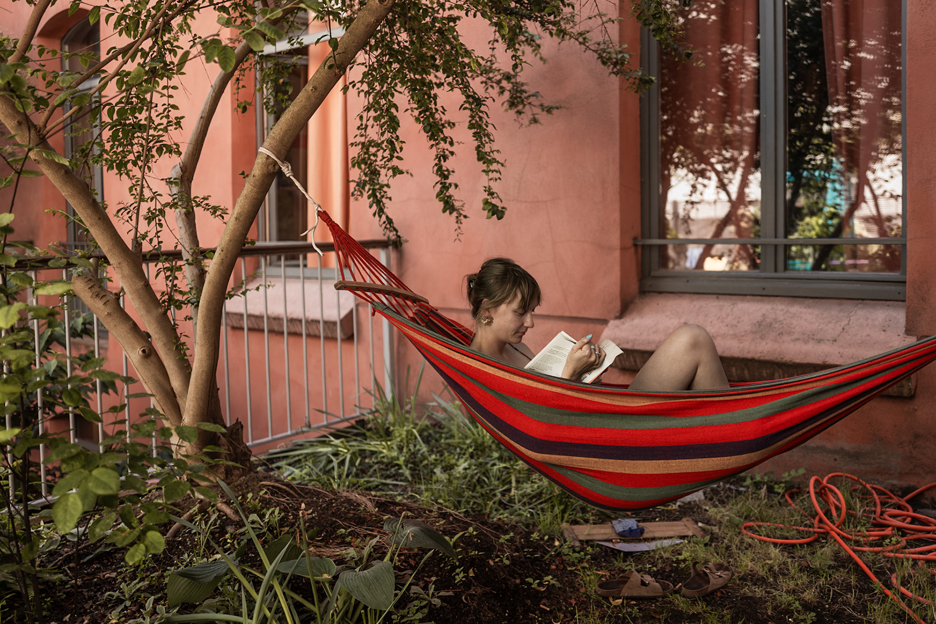 Julie sits in the hammock on the AEPP terrace, immersed in a book. The quiet settingcreates a peaceful atmosphere, offering her a calm space to read and unwind. The scene captures a simple, reflective moment of student life, centered on rest and focus.Picture taken the 2026-05-27©Aurora Ghigino