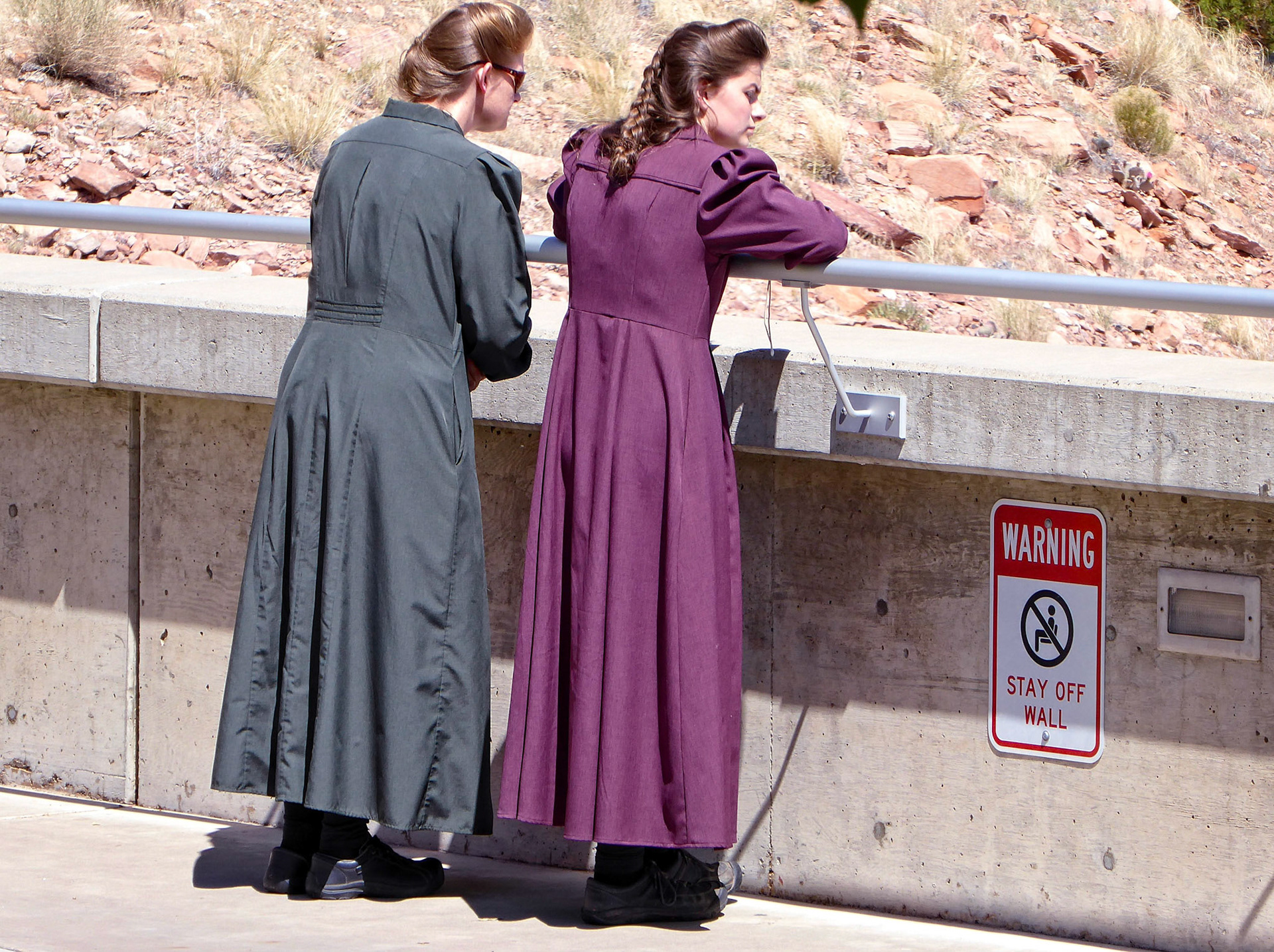 Two ladies dressed in traditional FLDS "prairie dresses" admiring the view from the Glen Canyon Dam.