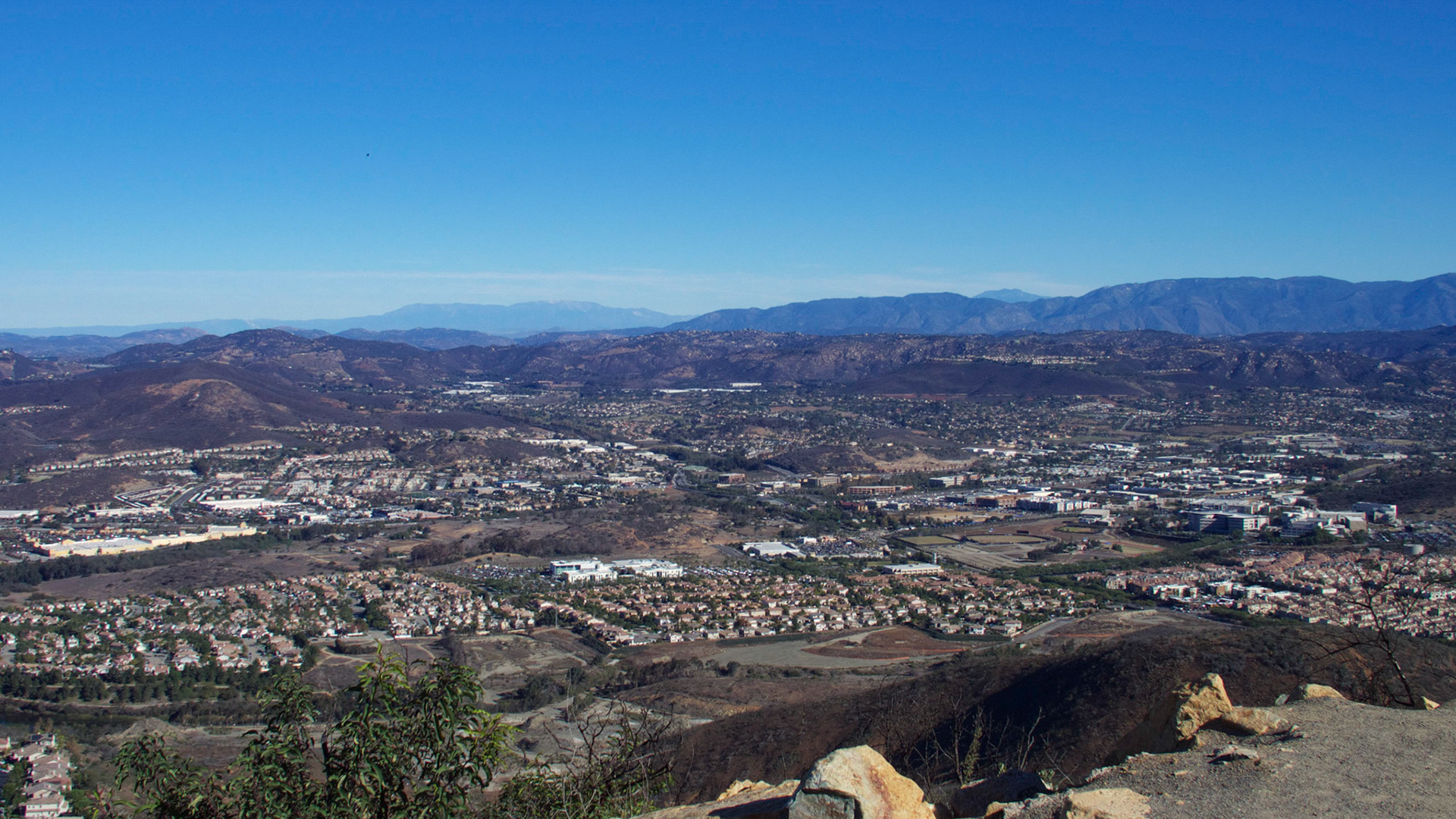 View from Double Peak Park, San Marcos, California. Looking northeast over San Marcos to the San Bernadino Mountains around Big Bear in the far distance and Mt. San Jacinto visible behind Palomar Mountain to the right.