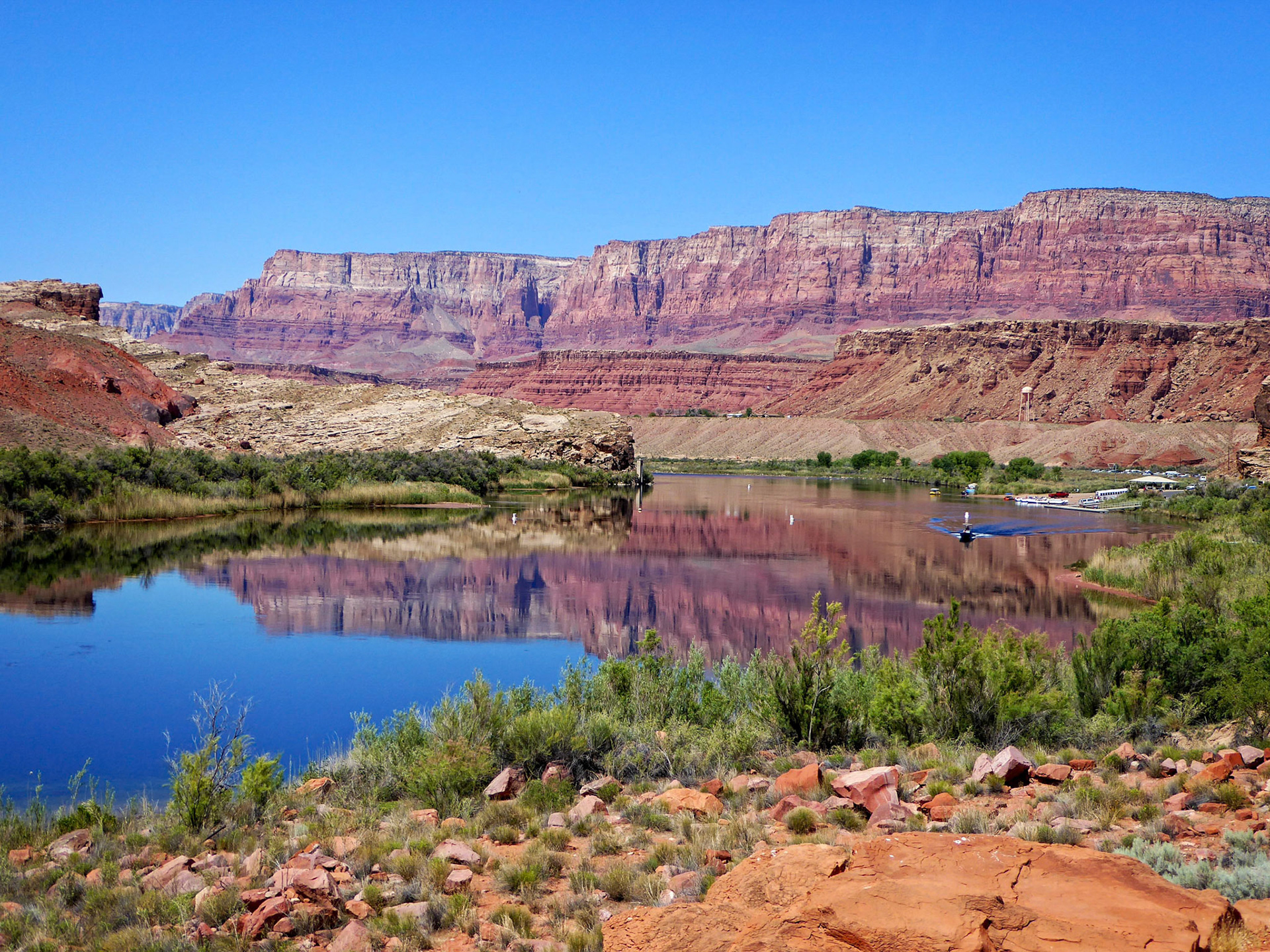 A calm morning on the Colorado River at Lees Ferry, Arizona with the Vermillion Cliffs in the background.