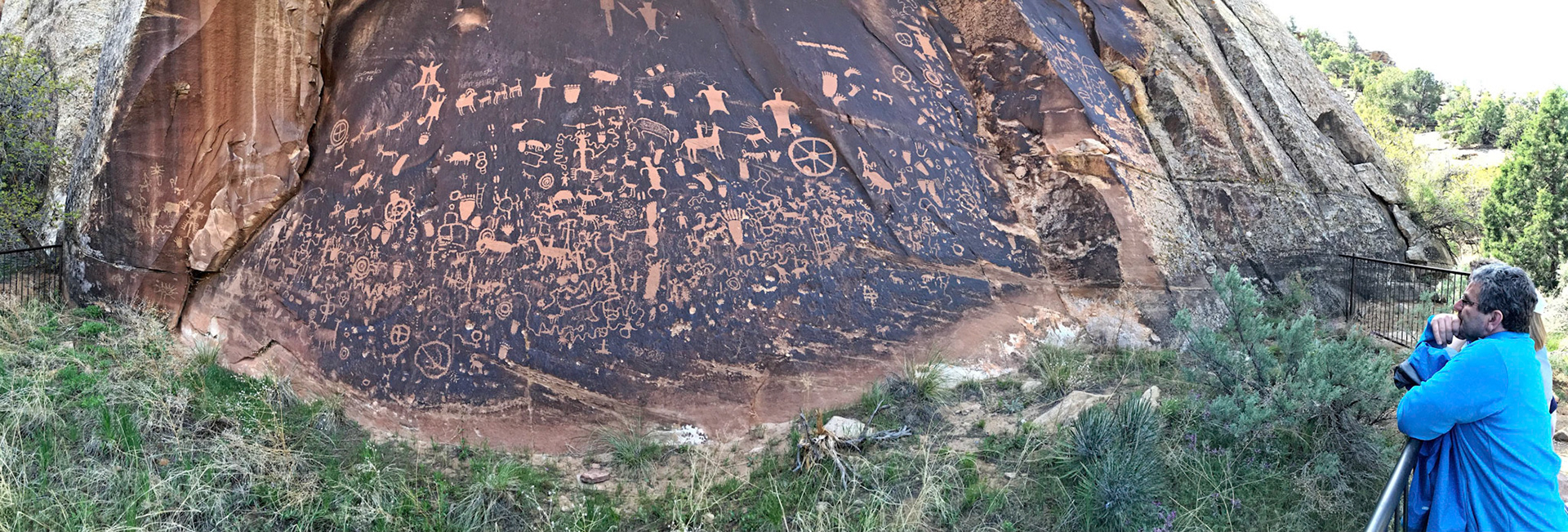 Serge studying the Newspaper Rock in Indian Creek Canyon, San Juan County, Utah. Over 650 rock art designs were carved into the Wingate sandstone by Native Americans during both the prehistoric and historic periods. In Navajo, the rock is called "Tse' Hone'" which translates to a rock that tells a story.