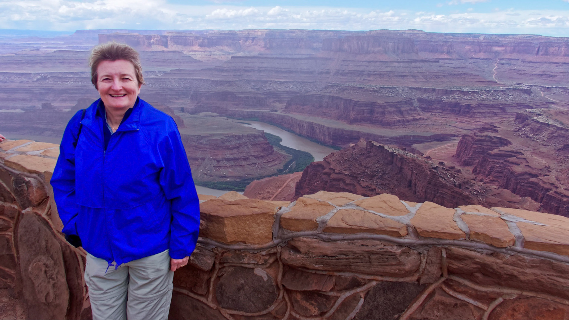 Jenny at Dead Horse Point, with the Colorado River and Island in the Sky beyond.