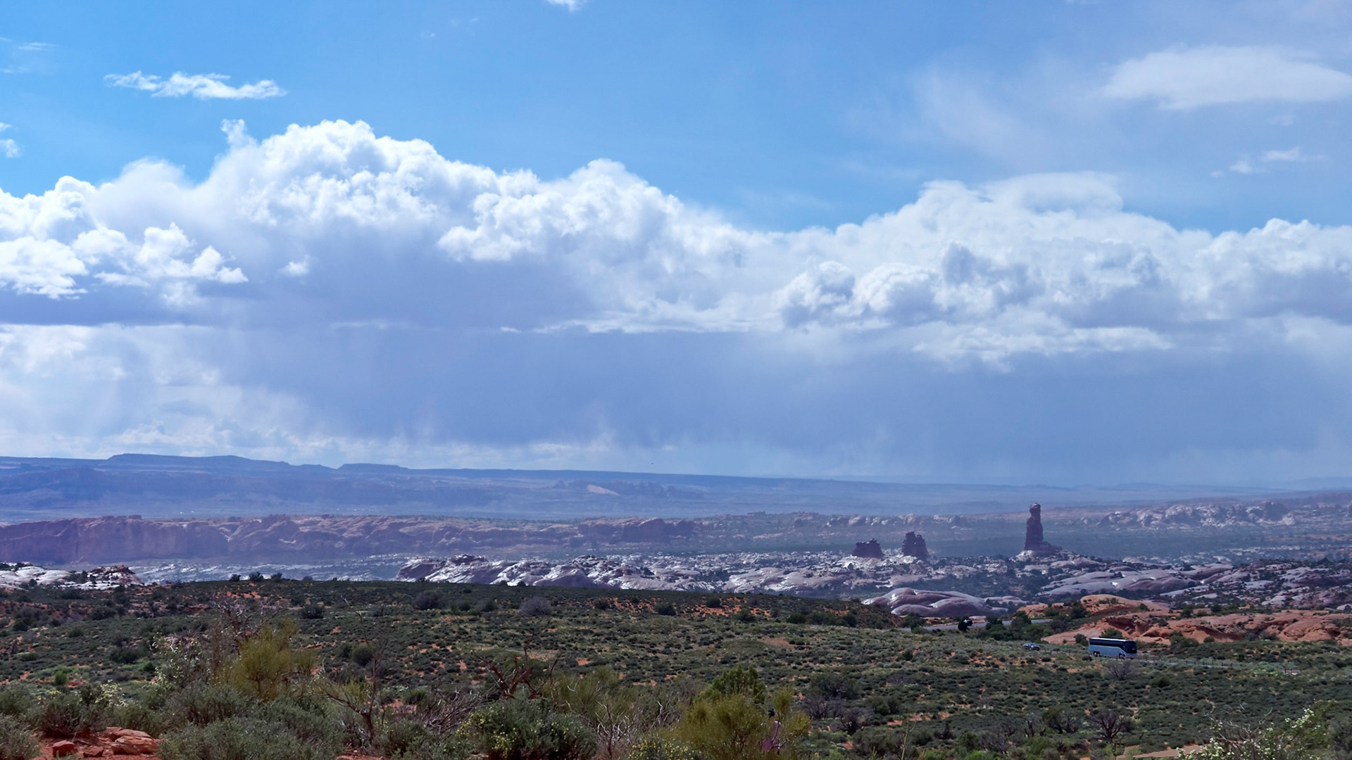 Balanced Rock and wet slickrock after a short, sharp shower in Arches National Park.