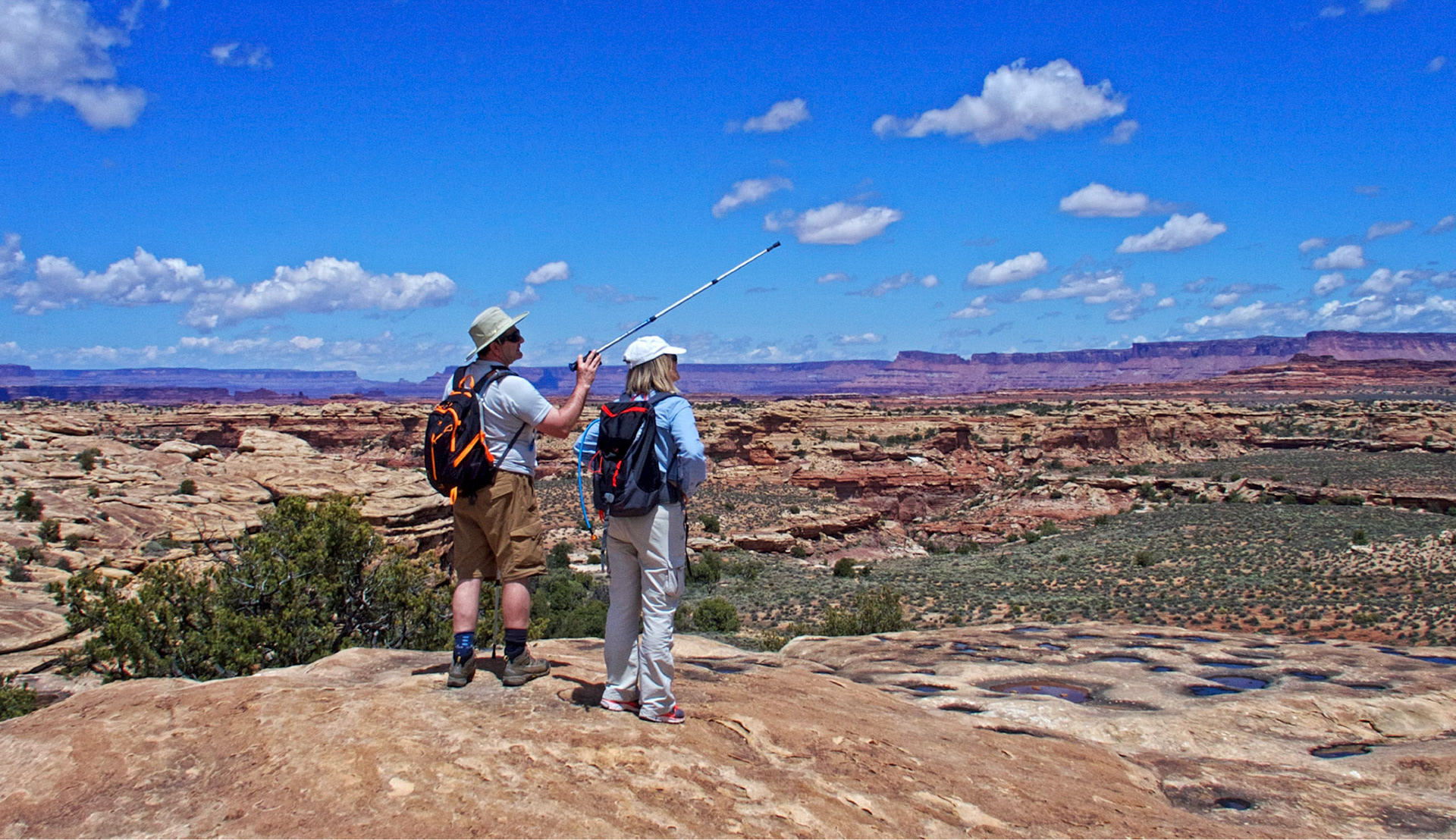 Serge and Judith on the Slickrock Foot Trail looking northeast. Needles Overlook is on the right center horizon.