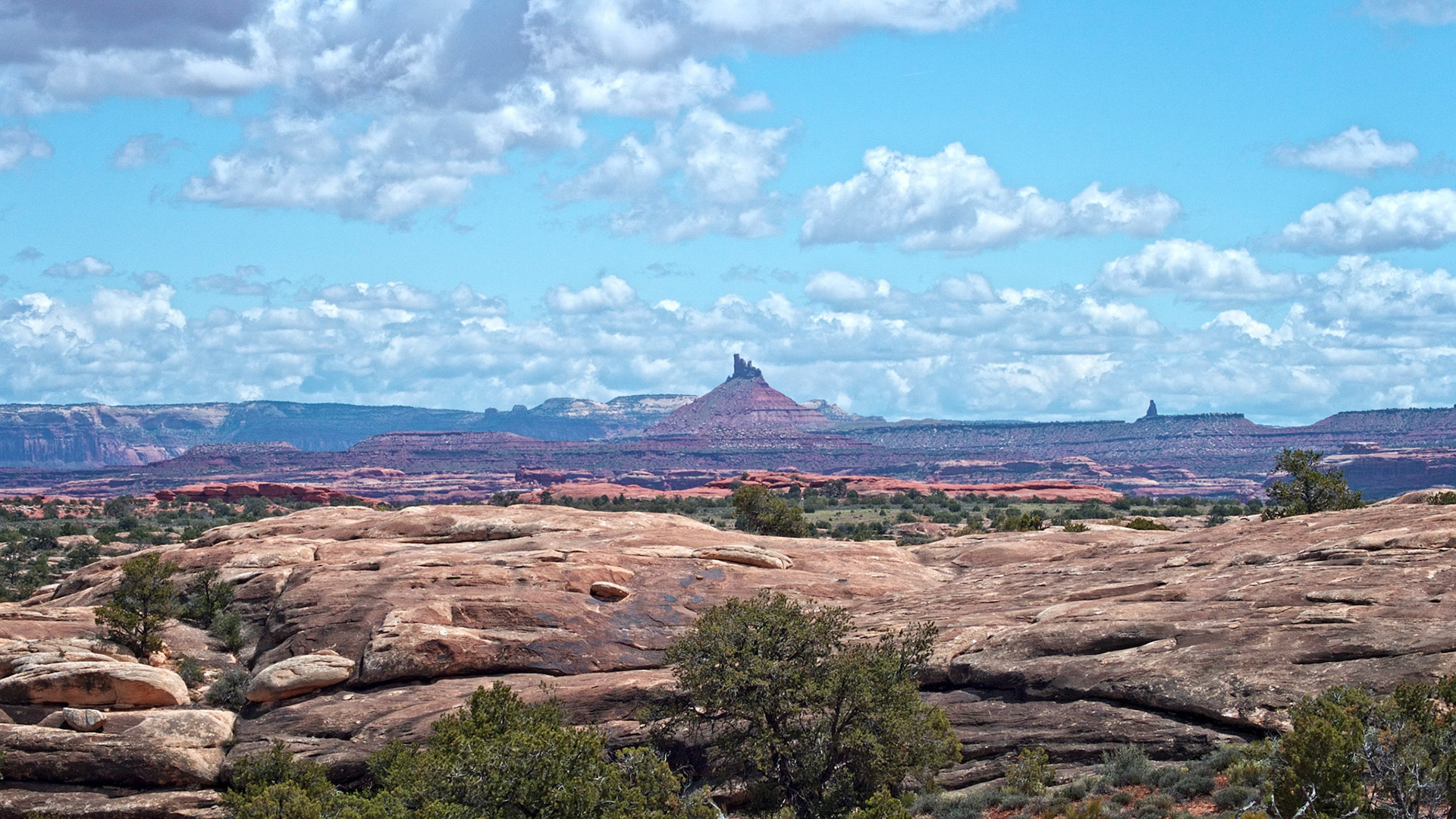 North Six Shooter Peak in the Bridger Jack Mesa area of Utah, just outside the Needles District of Canyonlands National Park. On the right horizon is South Six Shooter Peak. The photo was taken from the Slickrock Foot Trail in the park.