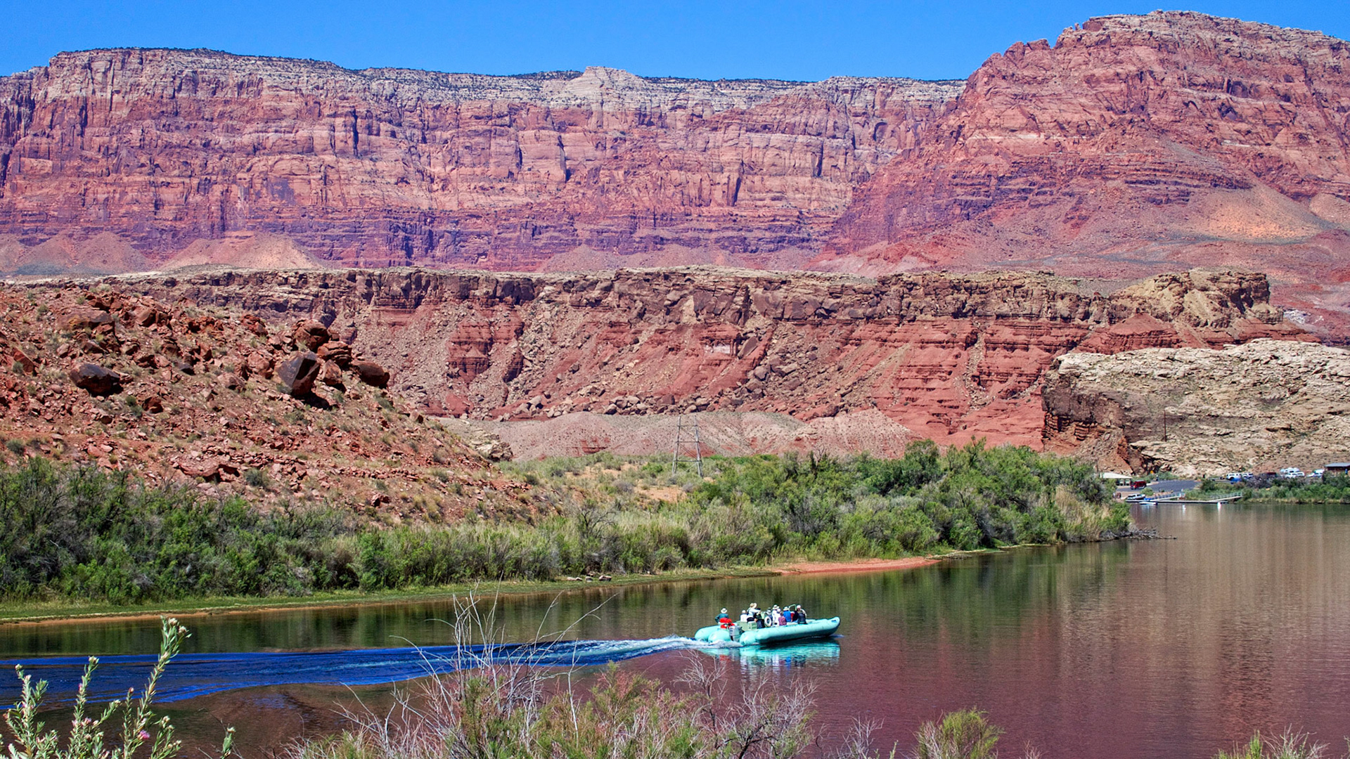 A small inflatable heads downstream on the Colorado River above Lees Ferry, Arizona.