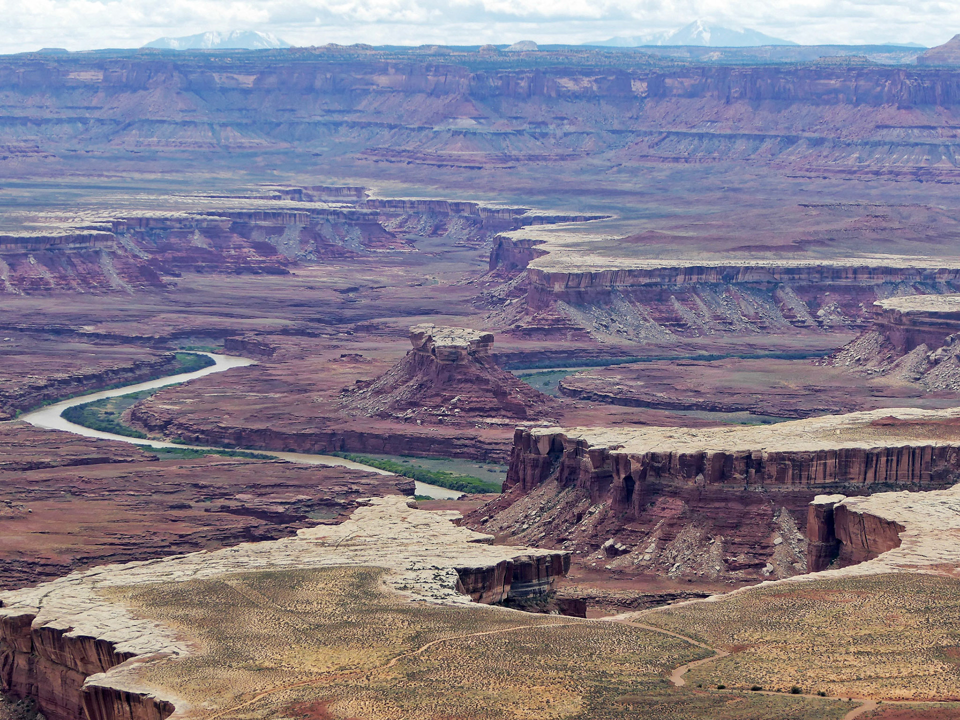 View over to the Maze from the Green River Overlook, Island in the Sky.  In the center is the Turks Head and in the foreground the White Rim Trail. On the horizon are the Henry Mountains.
