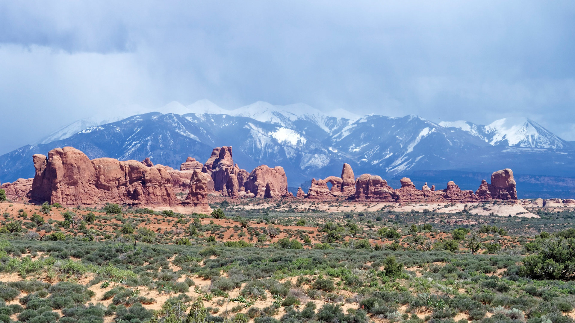 The La Sal mountains form a backdrop to the Windows Section of Arches National Park.  Turret Arch is in the center.