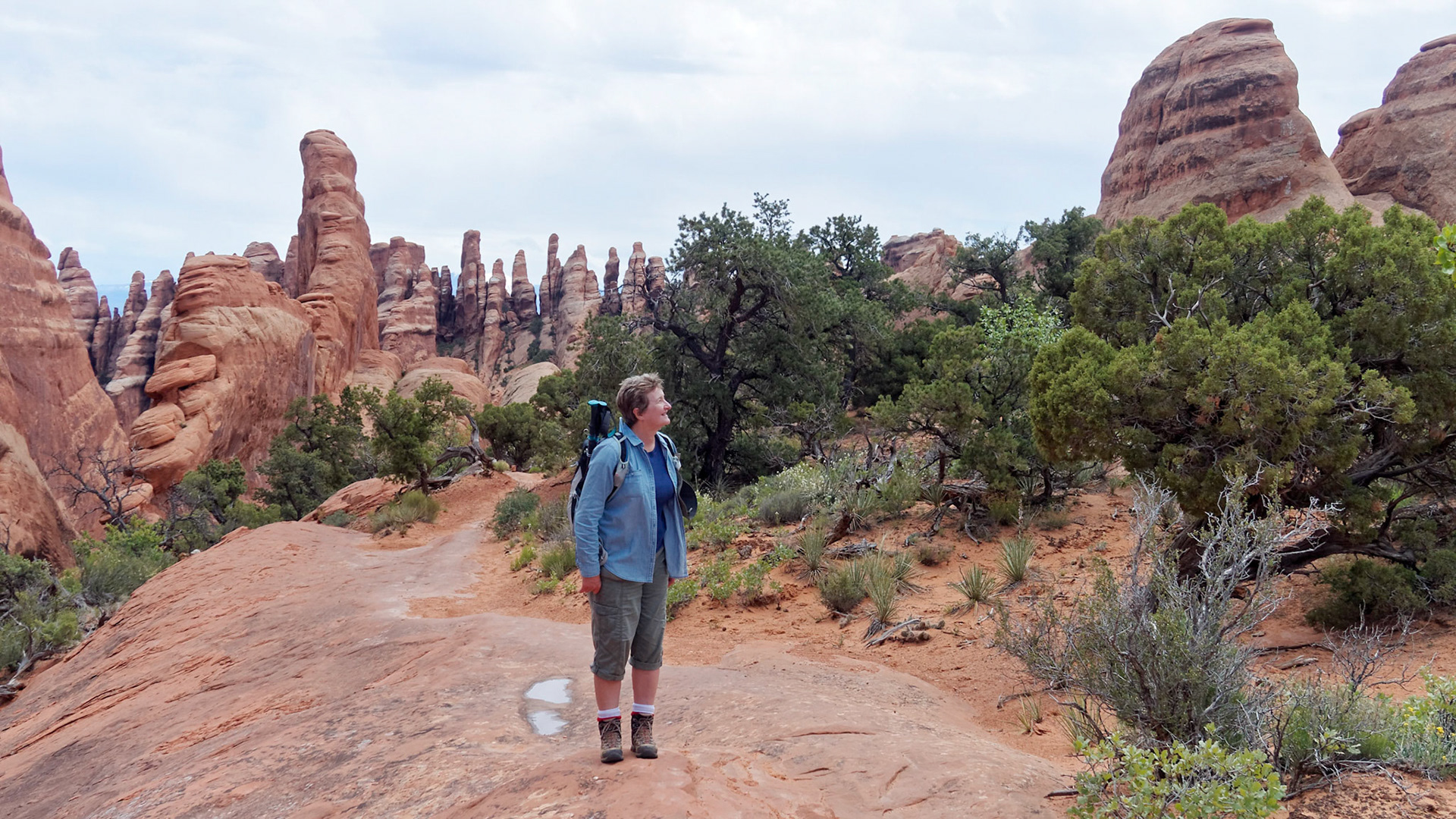 Jenny admiring the rock architecture on the Primitive Trail, Arches National Park.