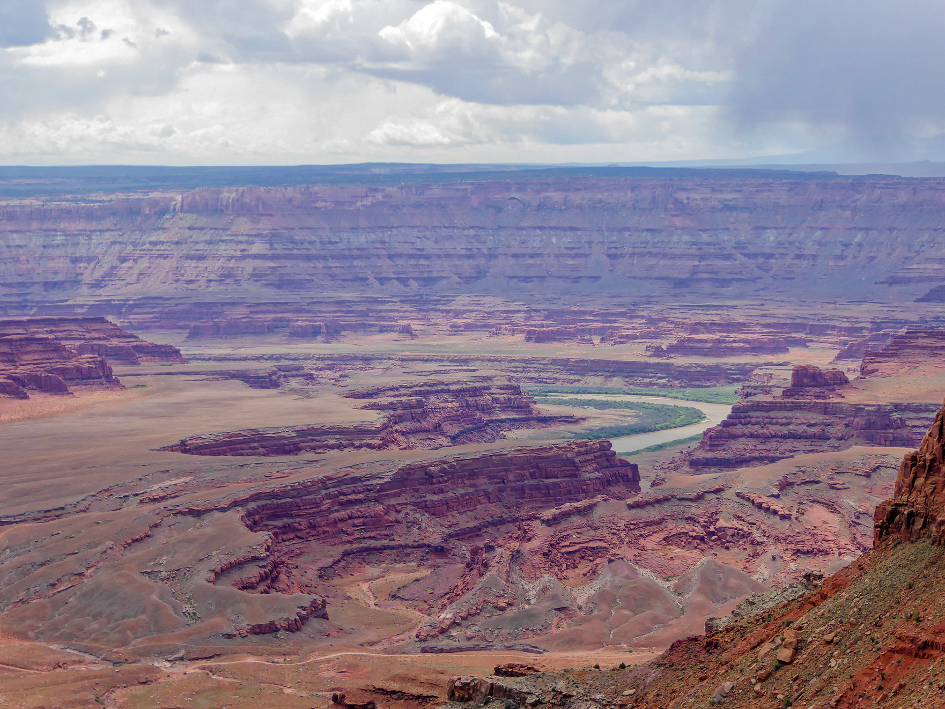 Looking out over the Colorado River on a cloudy day at Dead Horse Point.