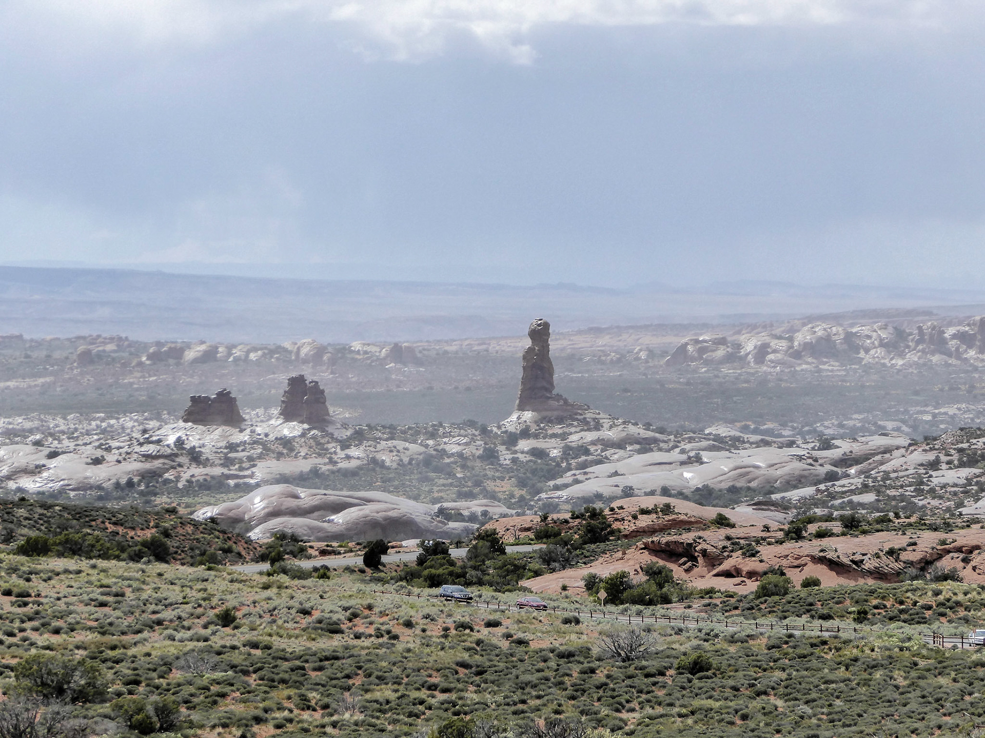 Balanced Rock and wet slickrock after a short, sharp shower in Arches National Park.