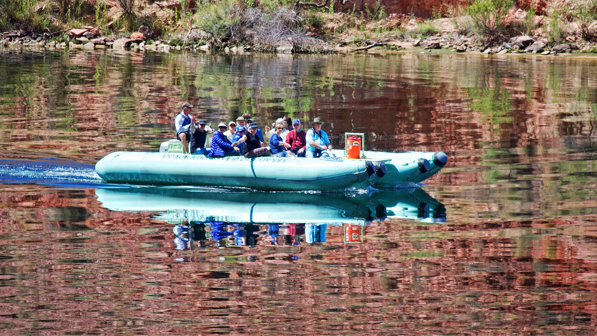 A small inflatable heads downstream on the Colorado River above Lees Ferry, Arizona.