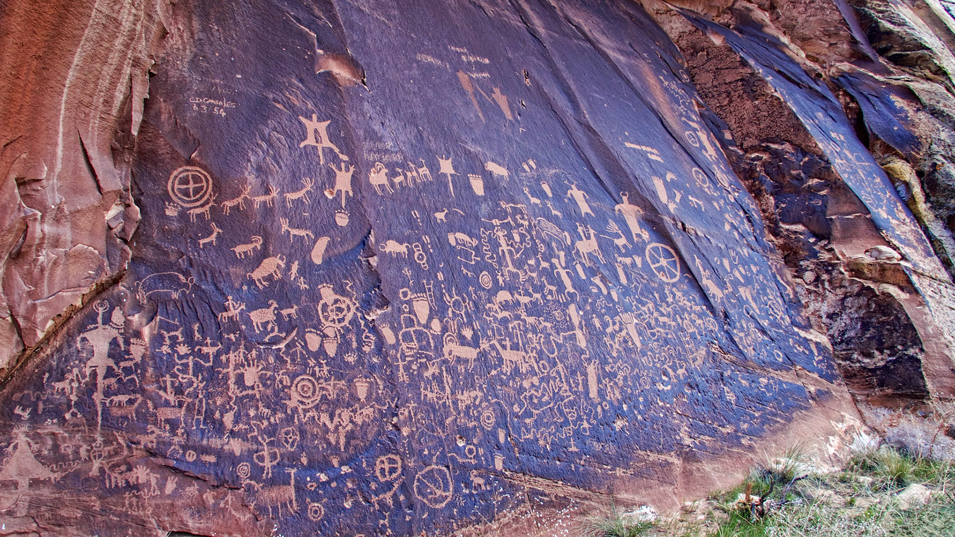 Newspaper Rock in Indian Creek Canyon, San Juan County, Utah. Over 650 rock art designs were carved into the Wingate sandstone by Native Americans during both the prehistoric and historic periods. In Navajo, the rock is called "Tse' Hone'" which translates to a rock that tells a story.