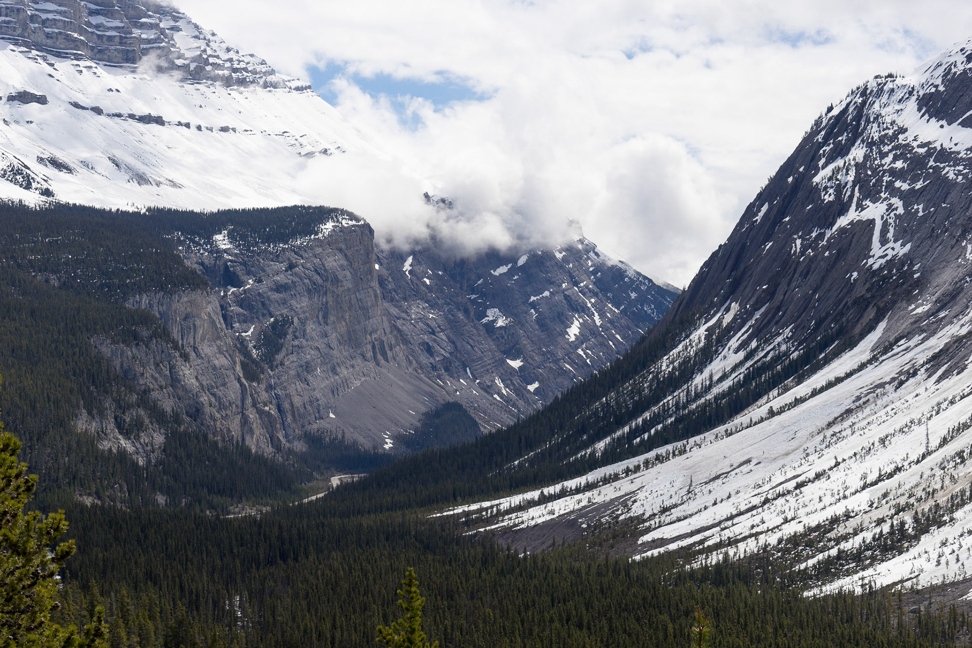 Enourmous mountains, with the Icefields Parkway winding between them.