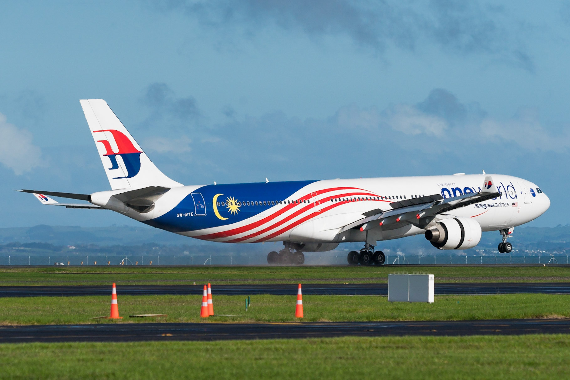 Malaysia Airlines Airbus A330-300 9M-MTE arriving in Auckland, sporting the One World logo on the forward half.