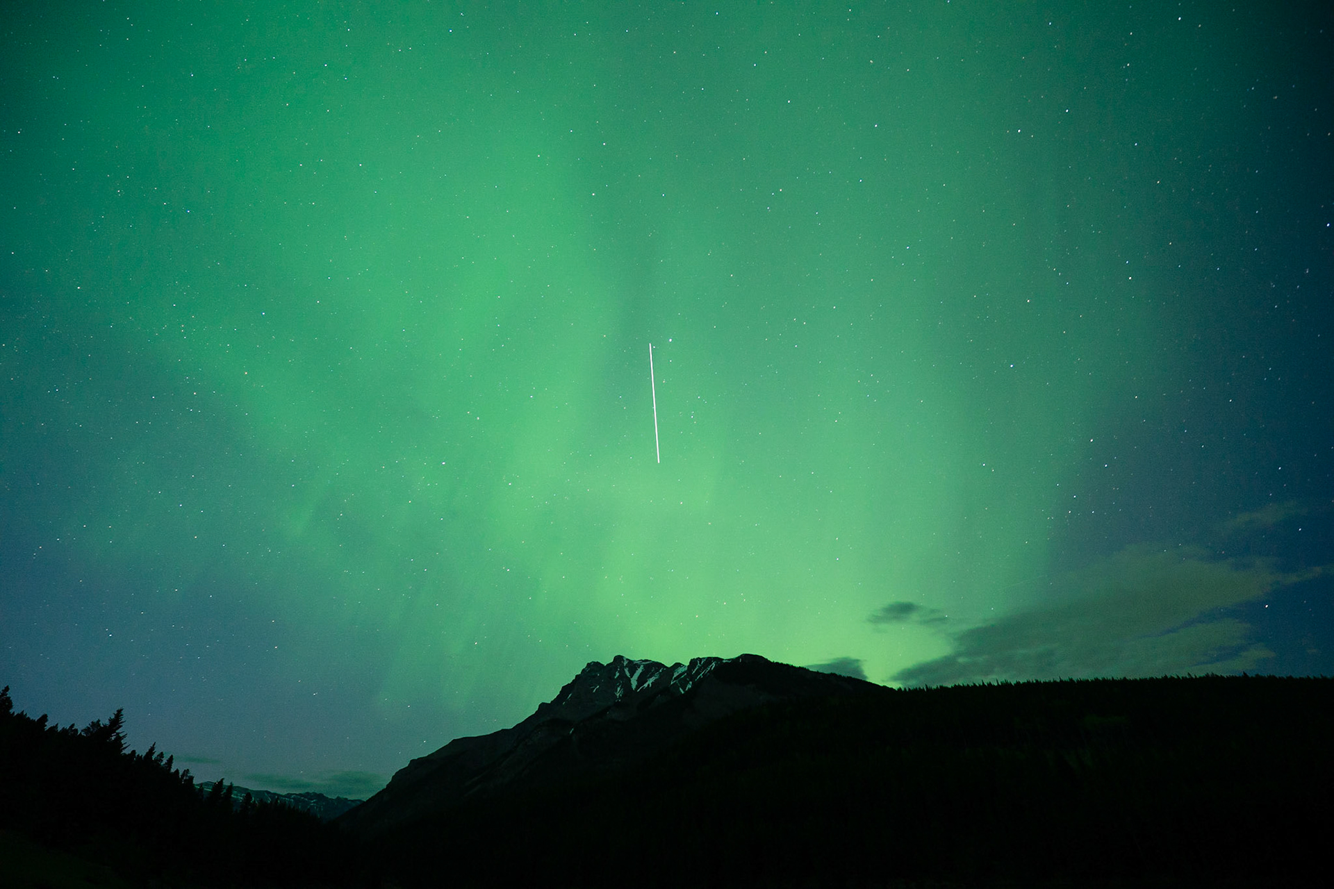 The International Space Station transiting overhead Mount Girouard, seen from Two Jack Lake.