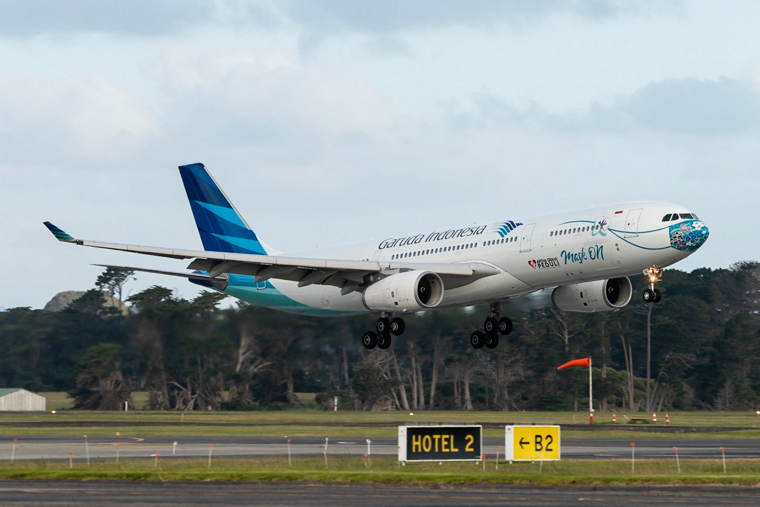 Garuda Indonesia Airbus A330-300 PH-GHC arriving in Auckland, showing signs of the times.