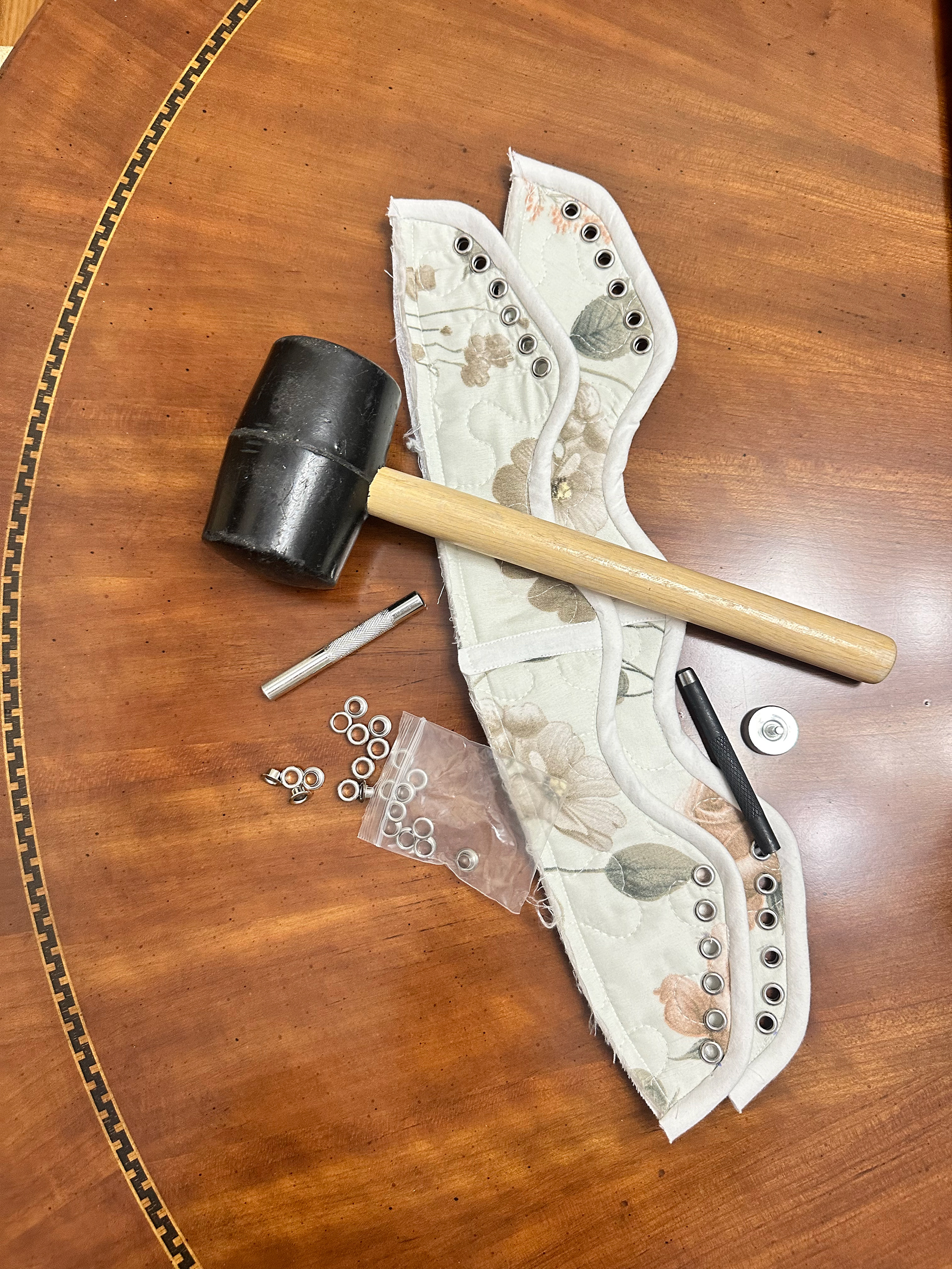 The progress of the shoe after putting in the grommets.