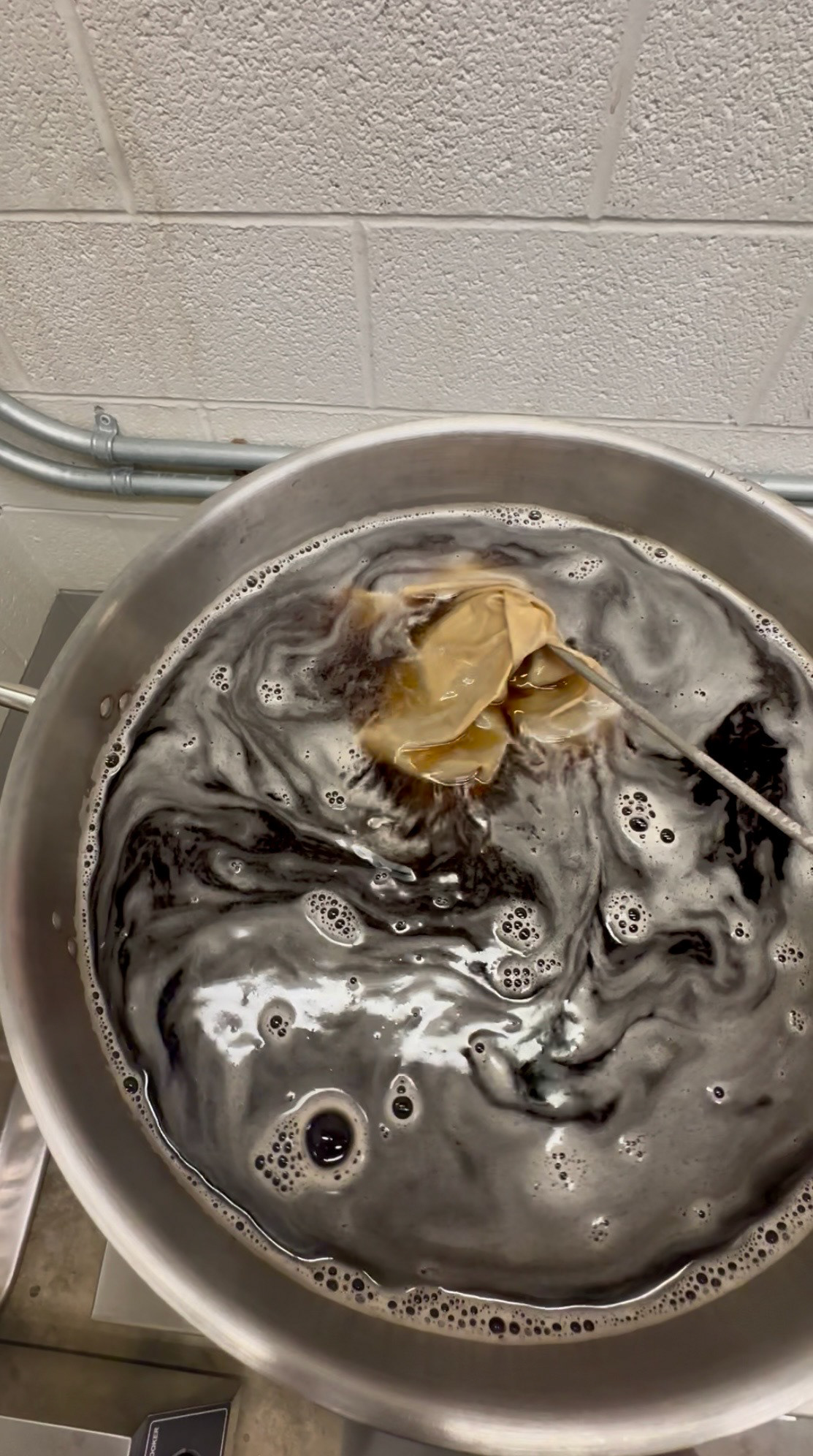 Dyeing the fabric over a large stove.